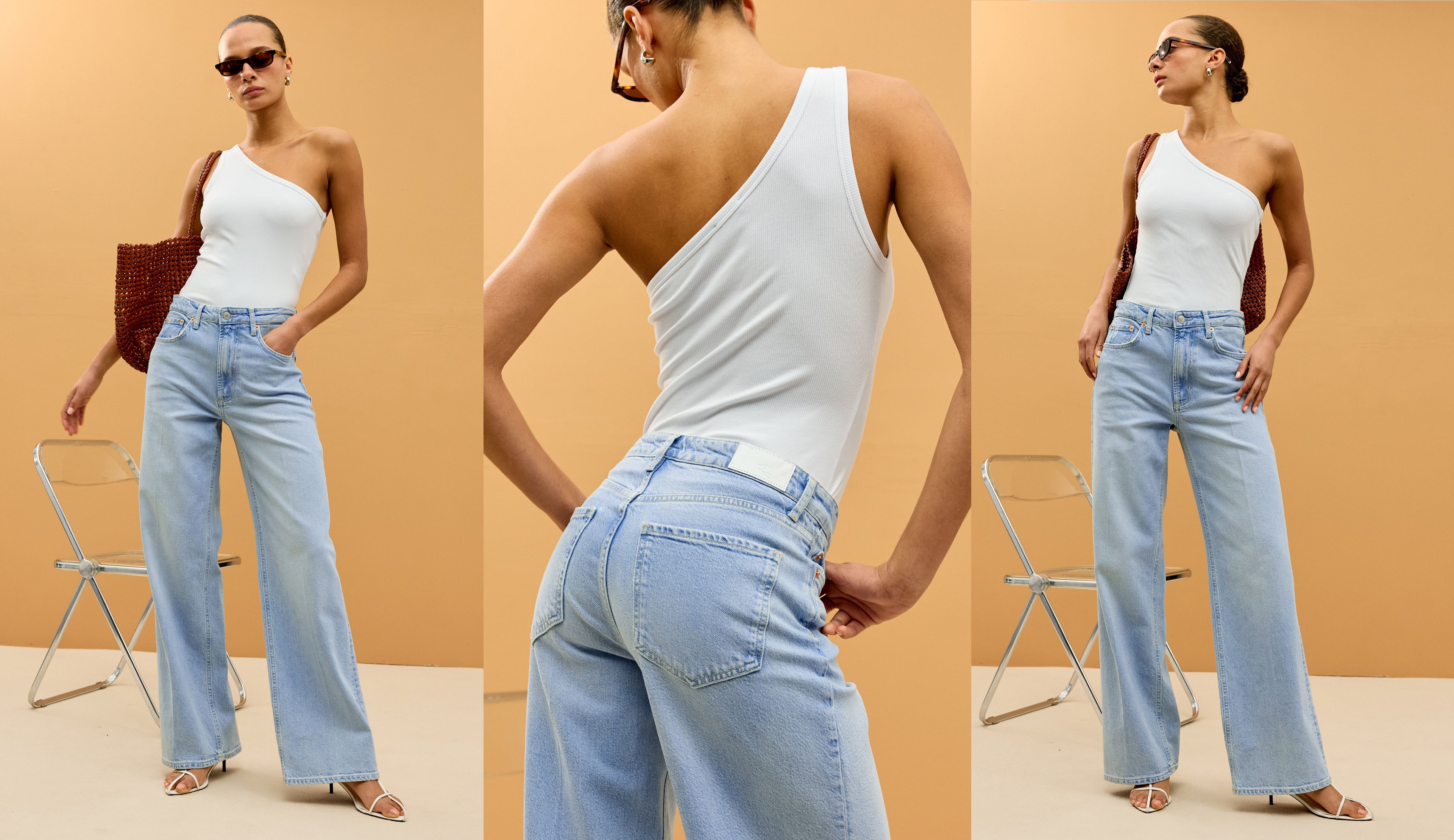 Woman wearing a white one-shoulder top and light blue jeans against an orange background