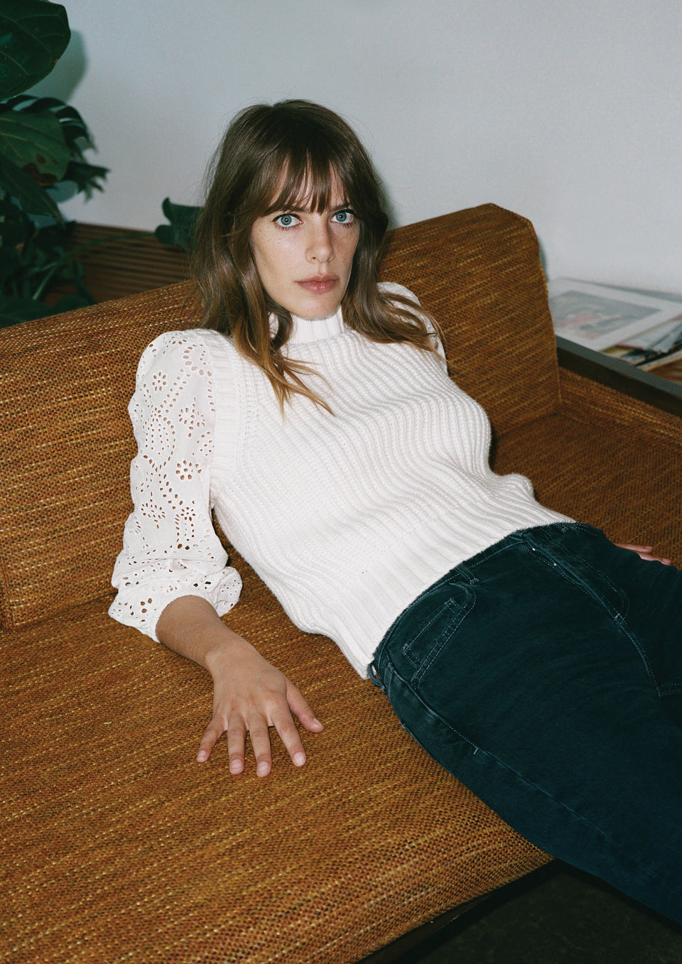 EDITORIAL IMAGE OF MODEL LAYING DOWN WEARING DHALIA SWEATER