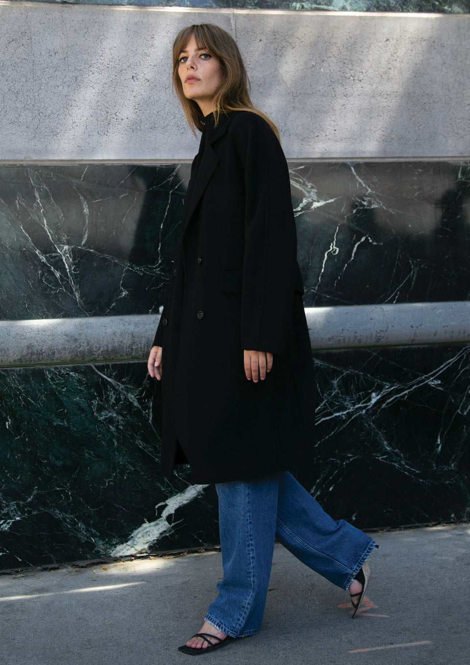 SIDE EDITORIAL IMAGE OF MODEL WEARING BRISTOL COAT AND SPEEDWAY 90S BOYFRIEND JEAN