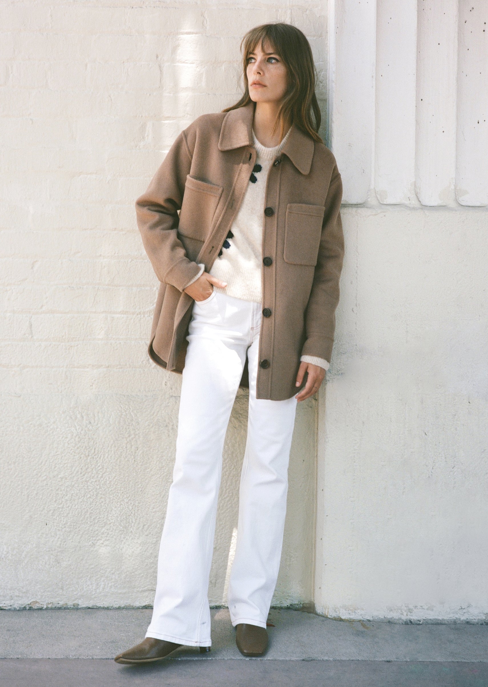 EDITORIAL IMAGE OF MODEL STANDING WITH ONE HAND IN POCKET