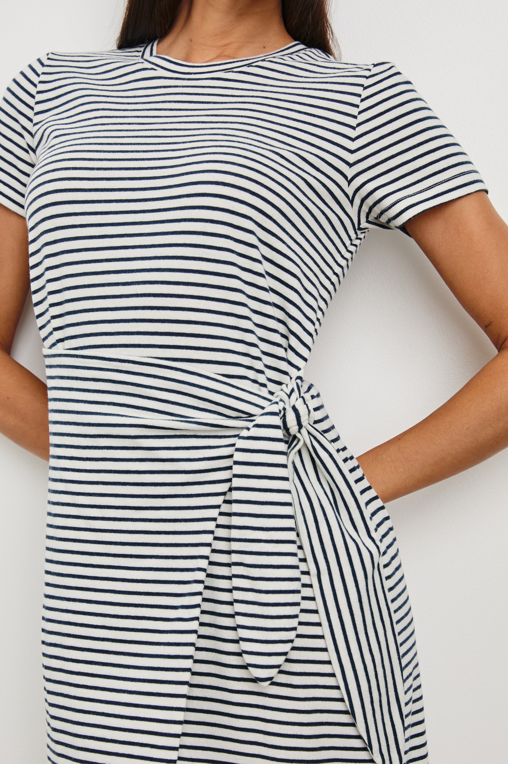 Edie Above-Knee Dress with Short Sleeves, Crew Neckline and Adjustable Wrap Tie At Waist in Ivory Navy Micro Stripe Colorway, Horizontal Stripes - Front View Featured on Model