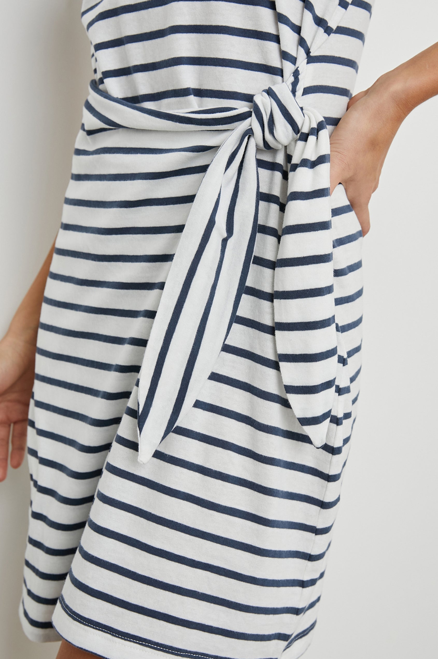 Edie Above-Knee Dress with Short Sleeves, Crew Neckline and Adjustable Wrap Tie At Waist in Ivory Navy Stripe Colorway, Horizontal Stripes - Side View Featured on Model
