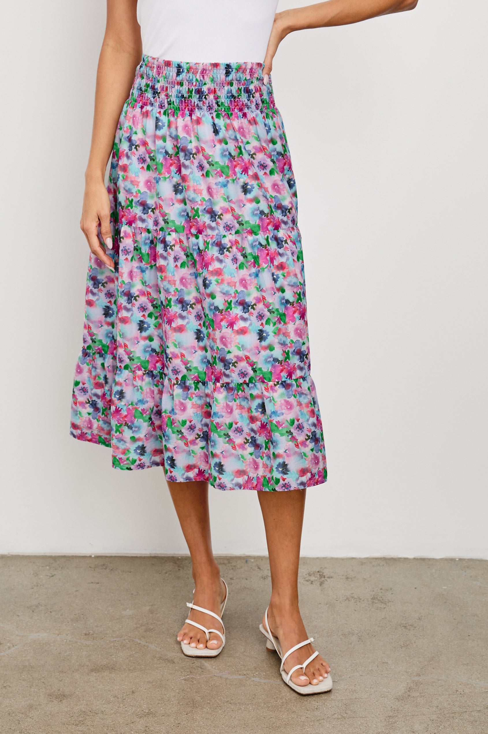 Edina Tiered Midi Skirt with Shirred High-Rise Waistline in Spring Floral Colorway, with mostly pinks and purples - Front View Featured on Model