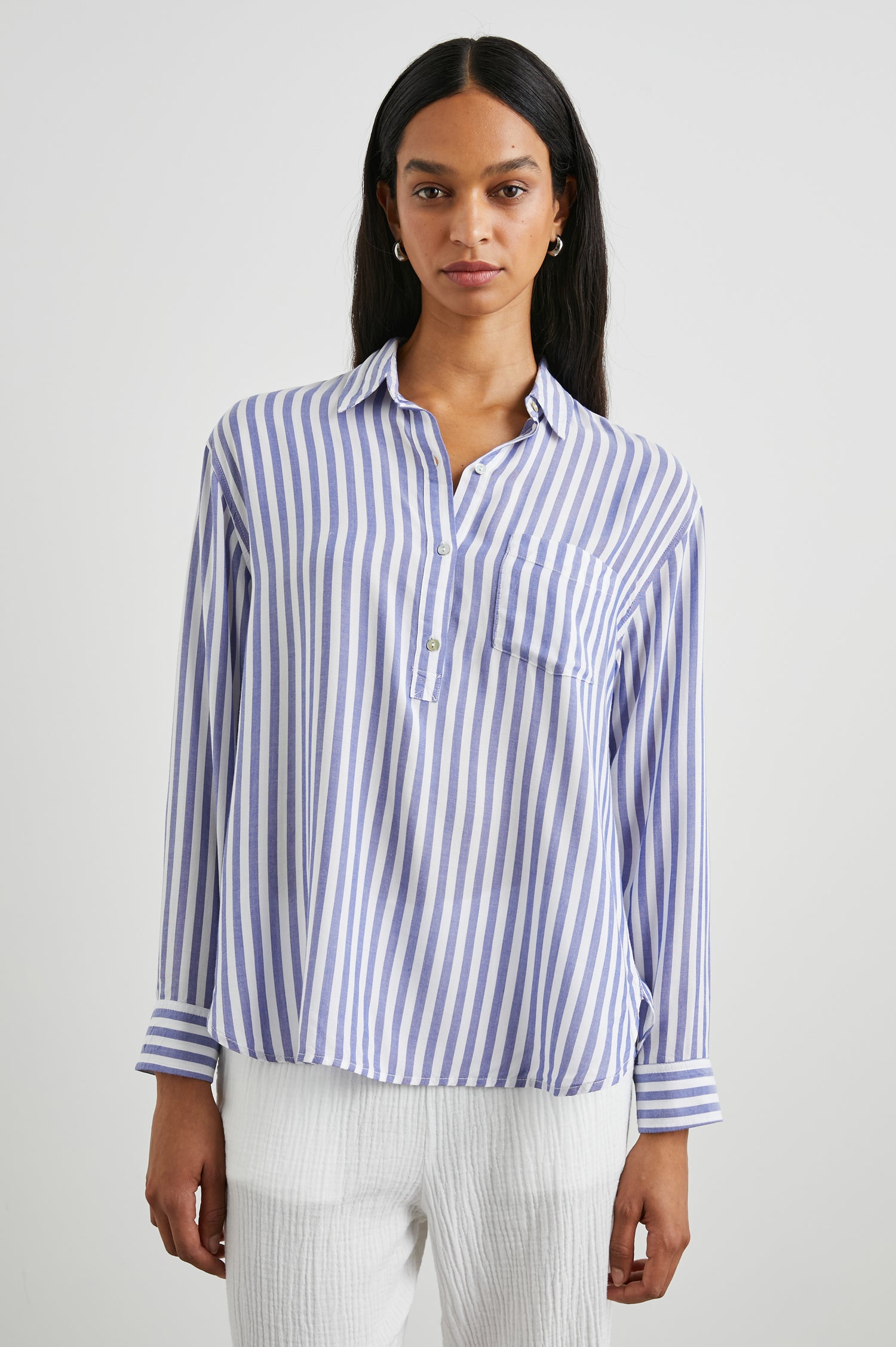 Elle Long Sleeve Shirt with a Four Button Placket, Buttoned Cuffs, a Chest Pocket and a Collar in Blue White Stripe Colorway, Vertical Stripes - Front View Featured on Model