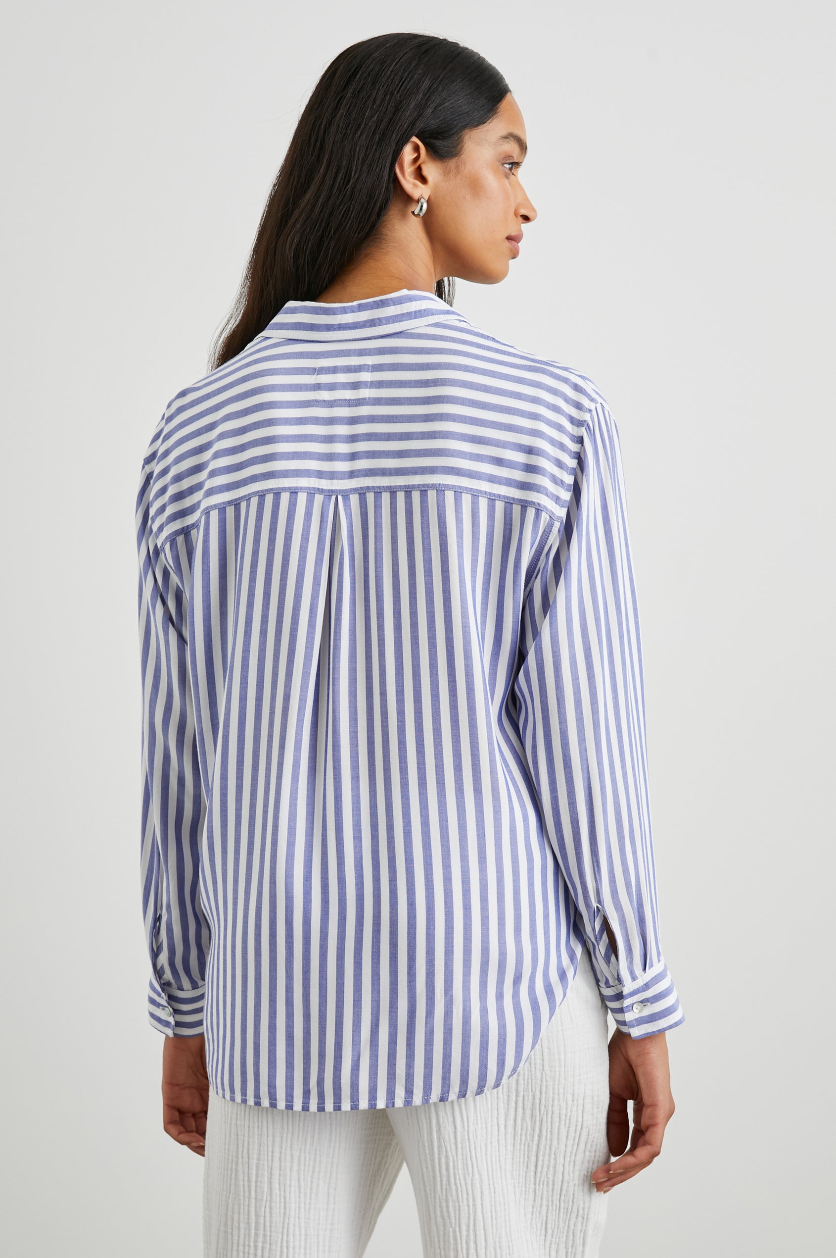 Elle Long Sleeve Shirt with a Four Button Placket, Buttoned Cuffs, a Chest Pocket and a Collar in Blue White Stripe Colorway, Vertical Stripes - Back View Featured on Model