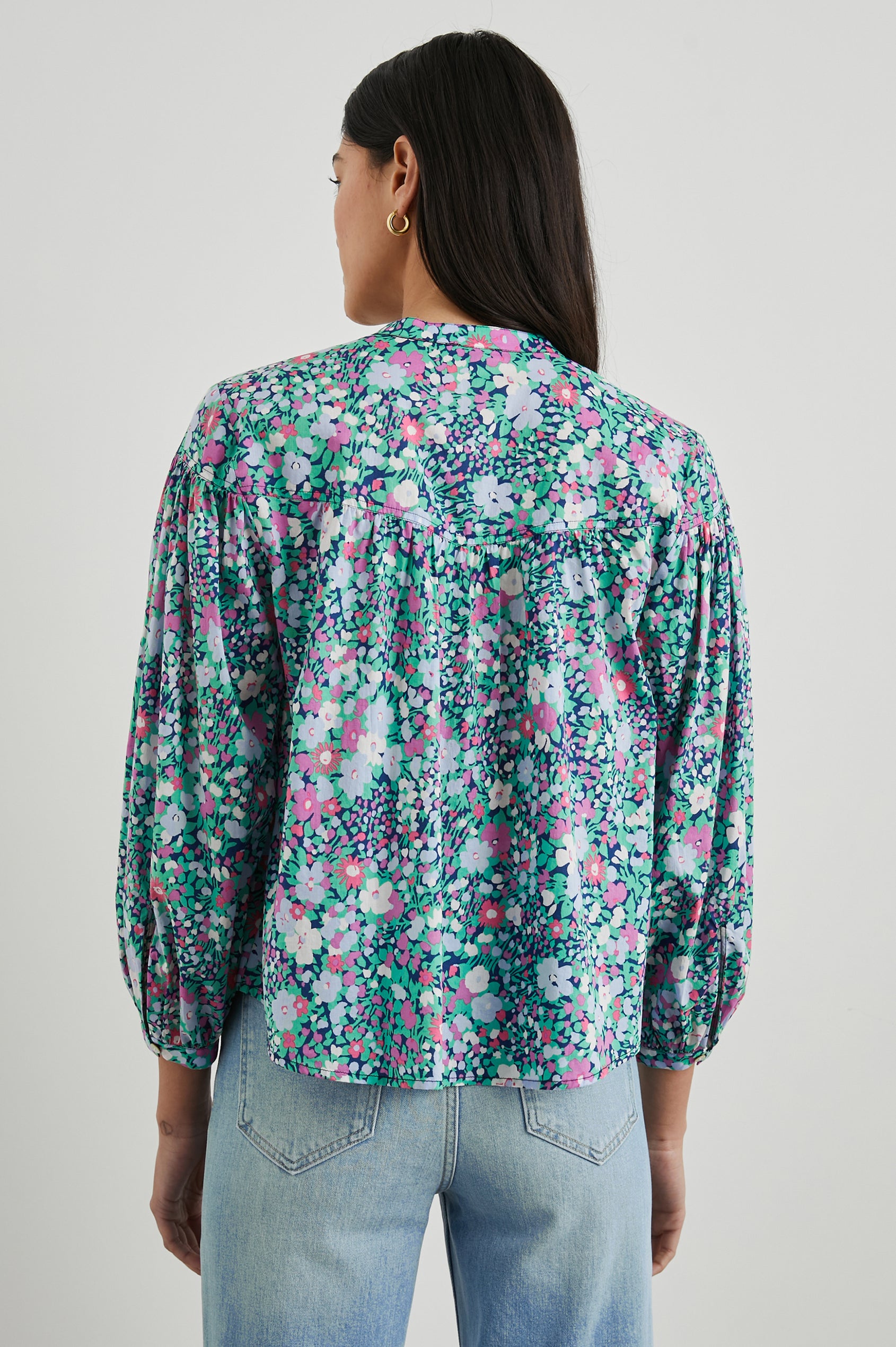 Ellison Top with Three-Quarter Sleeves, a Seven-Button Placket, and Button Cuffs in Navy Leilani Floral Colorway, Purples, Pinks and Greens on Navy - Back View Featured on Model 