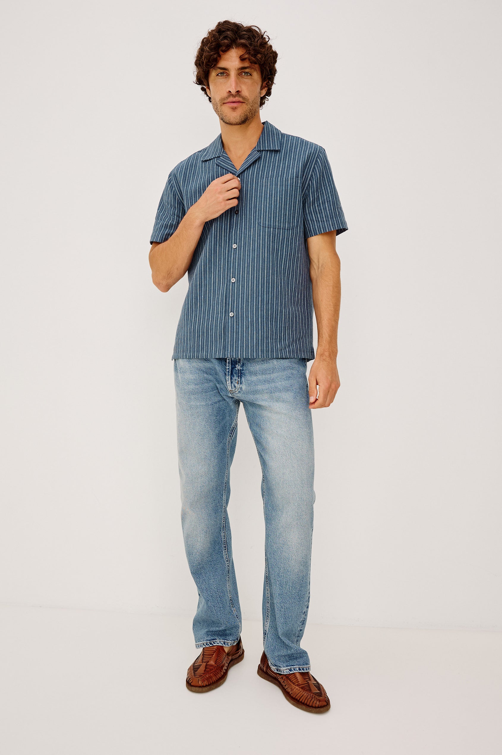Ely Camp Shirt in Homespun Weave With Collar, Short Sleeves, Front Buttons, and Slightly-Boxy Fit in Navy Multi Stripe Colorway - Full Body Front View Featured on Model