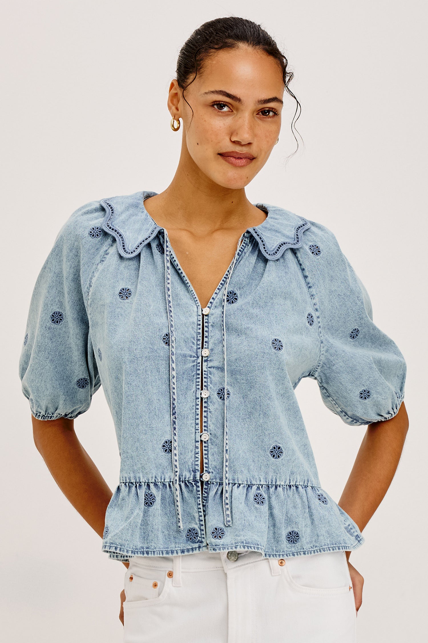 Emelie Top in TENCEL™ Denim With Embroidered Collar, Self-Tie V-Neckline, Front Buttons, Short Puff Sleeves, and Peplum Hem in Antique Indigo Colorway - Upper Body Front View Featured on Model