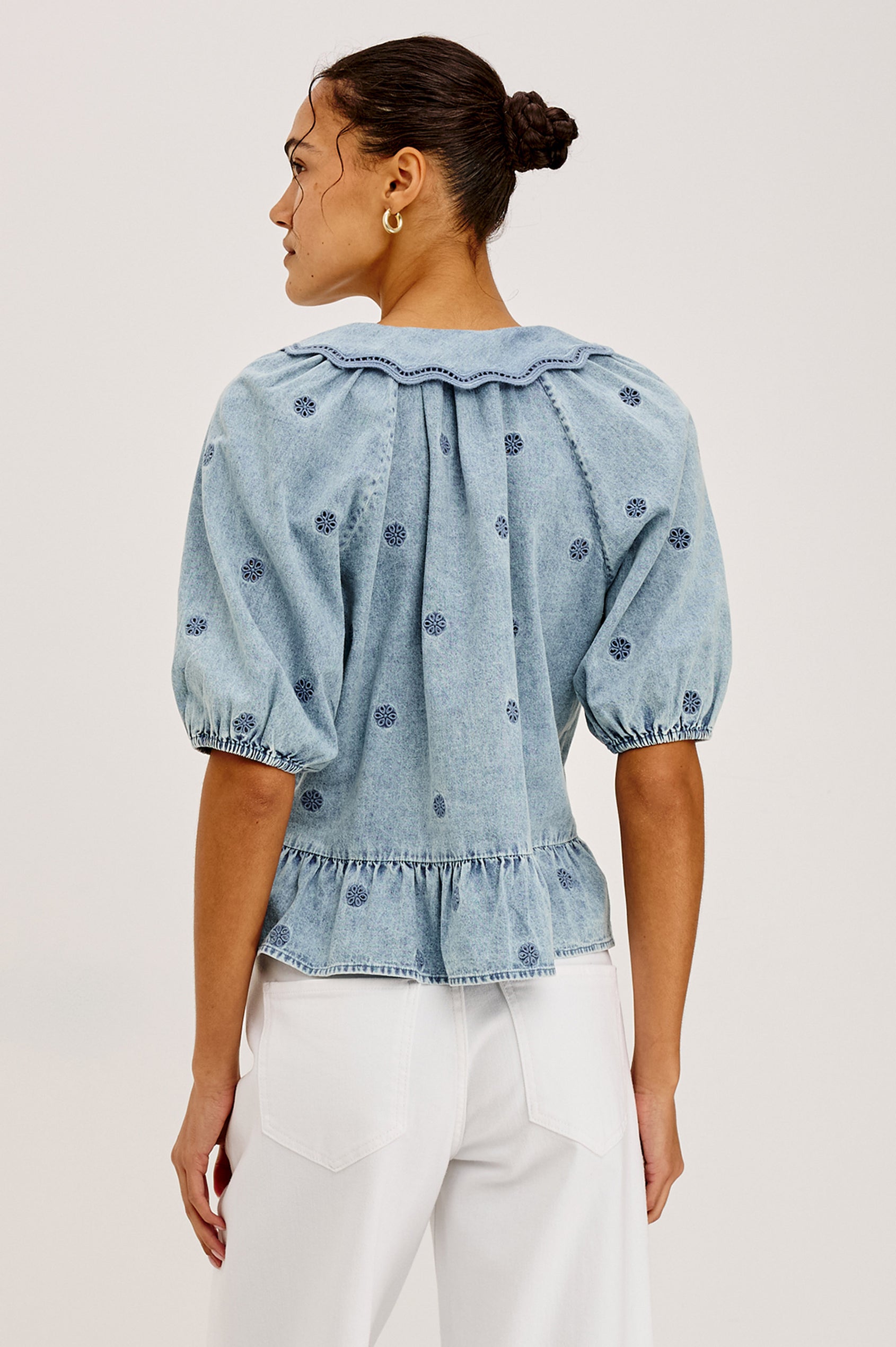 Emelie Top in TENCEL™ Denim With Embroidered Collar, Self-Tie V-Neckline, Front Buttons, Short Puff Sleeves, and Peplum Hem in Antique Indigo Colorway - Upper Body Back View Featured on Model