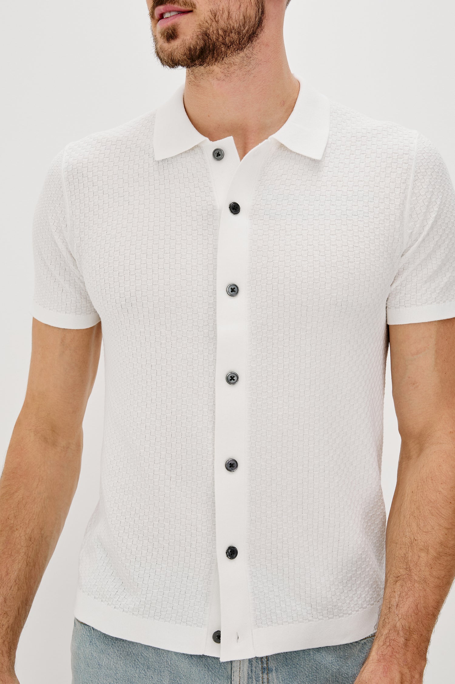 Emilio Collared Snap Front Knit Shirt with Short Sleeves and Contrast Black Snaps in White Colorway. Front Detail View Shown on Model.