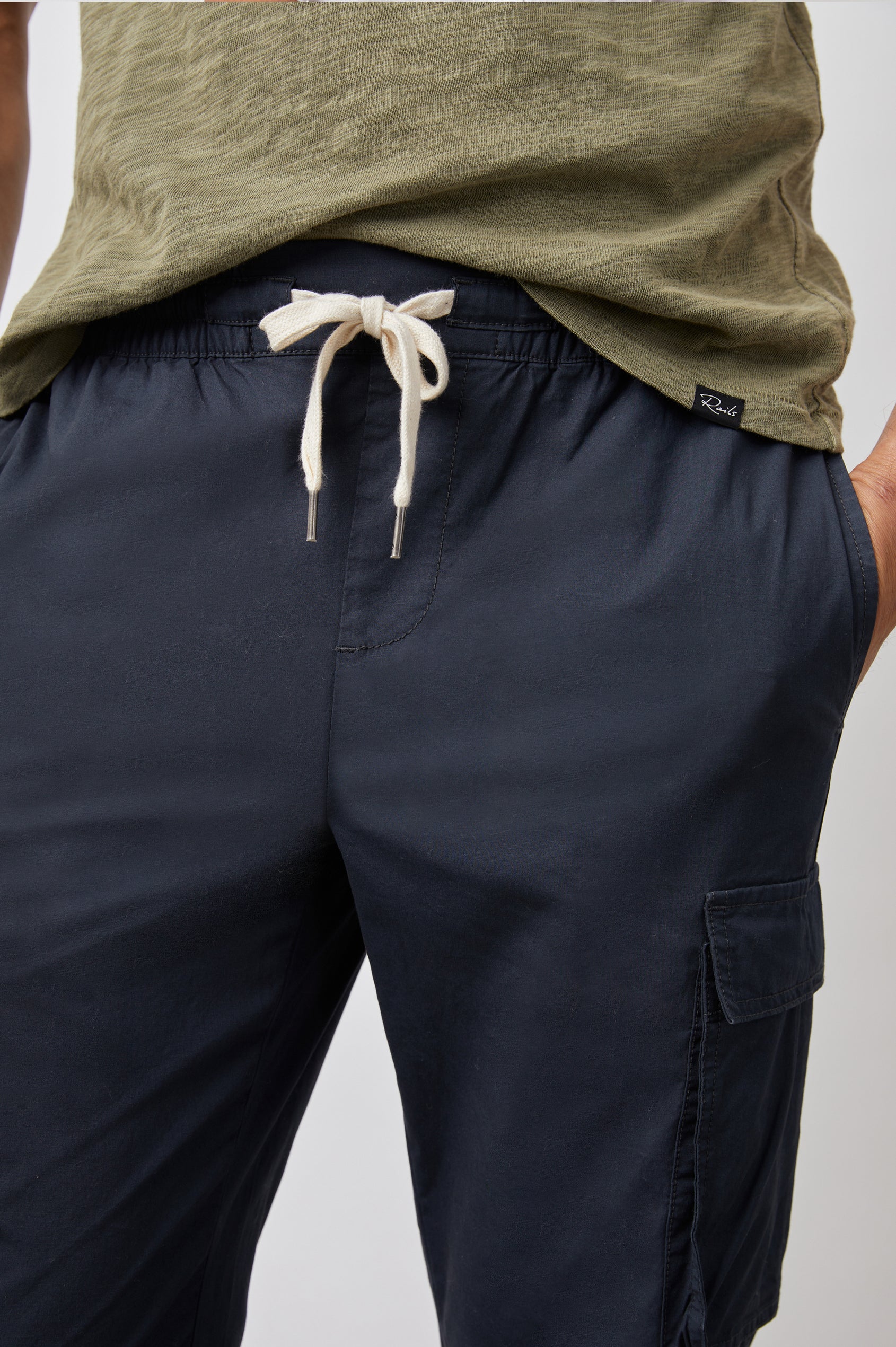 Emmerson Pants with a Drawstring Waist, Two Front Pockets, Two Side Flap Pockets and Two Back Welt Pockets in Washed Black Colorway - Front View Featured on Model