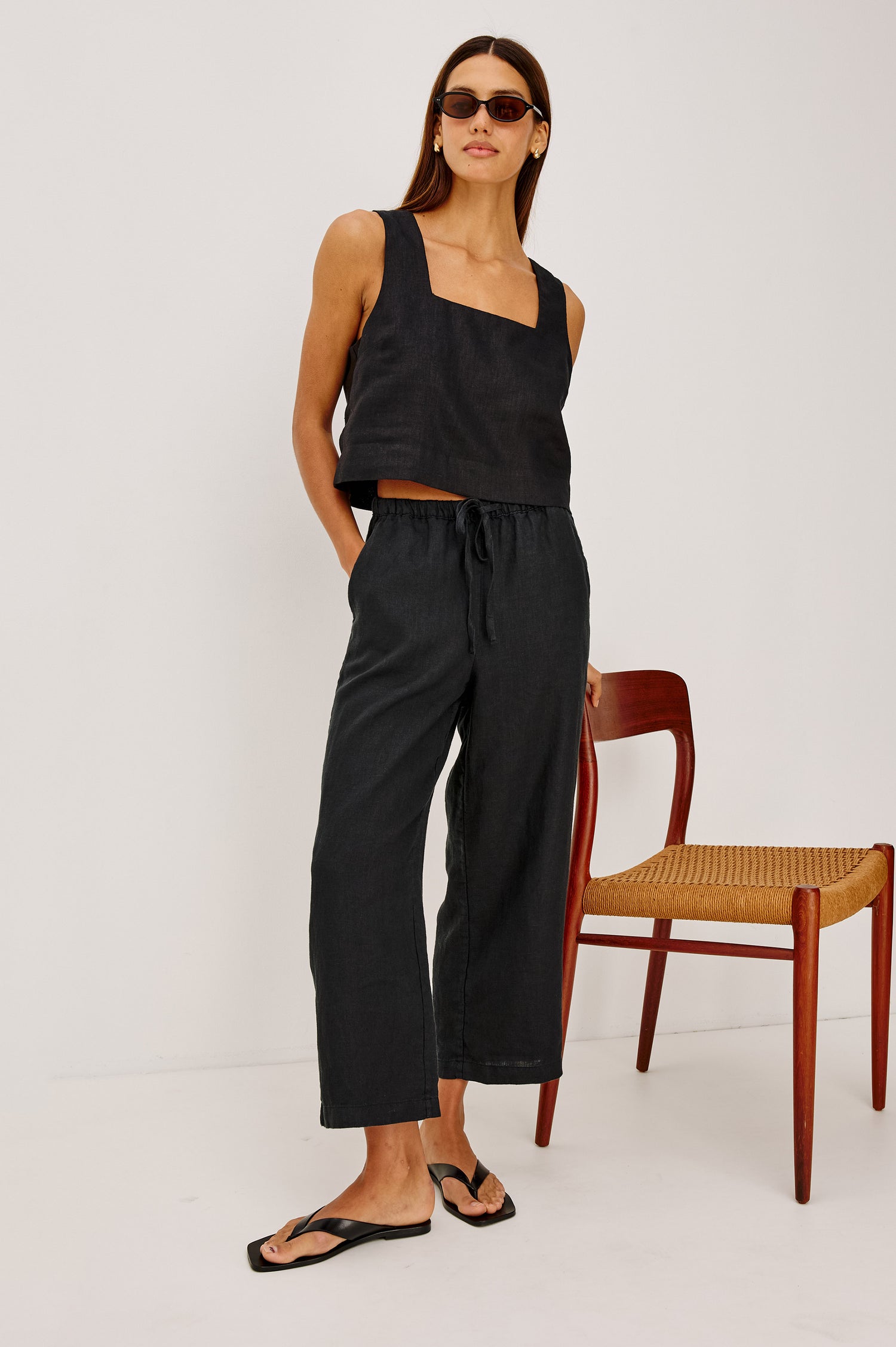 Emmie Crop Pant in Linen With Straight Legs, Adjustable Drawstring Waist Ties, and Side Pockets in Black Linen Colorway - Full Body Front View Featured on Model