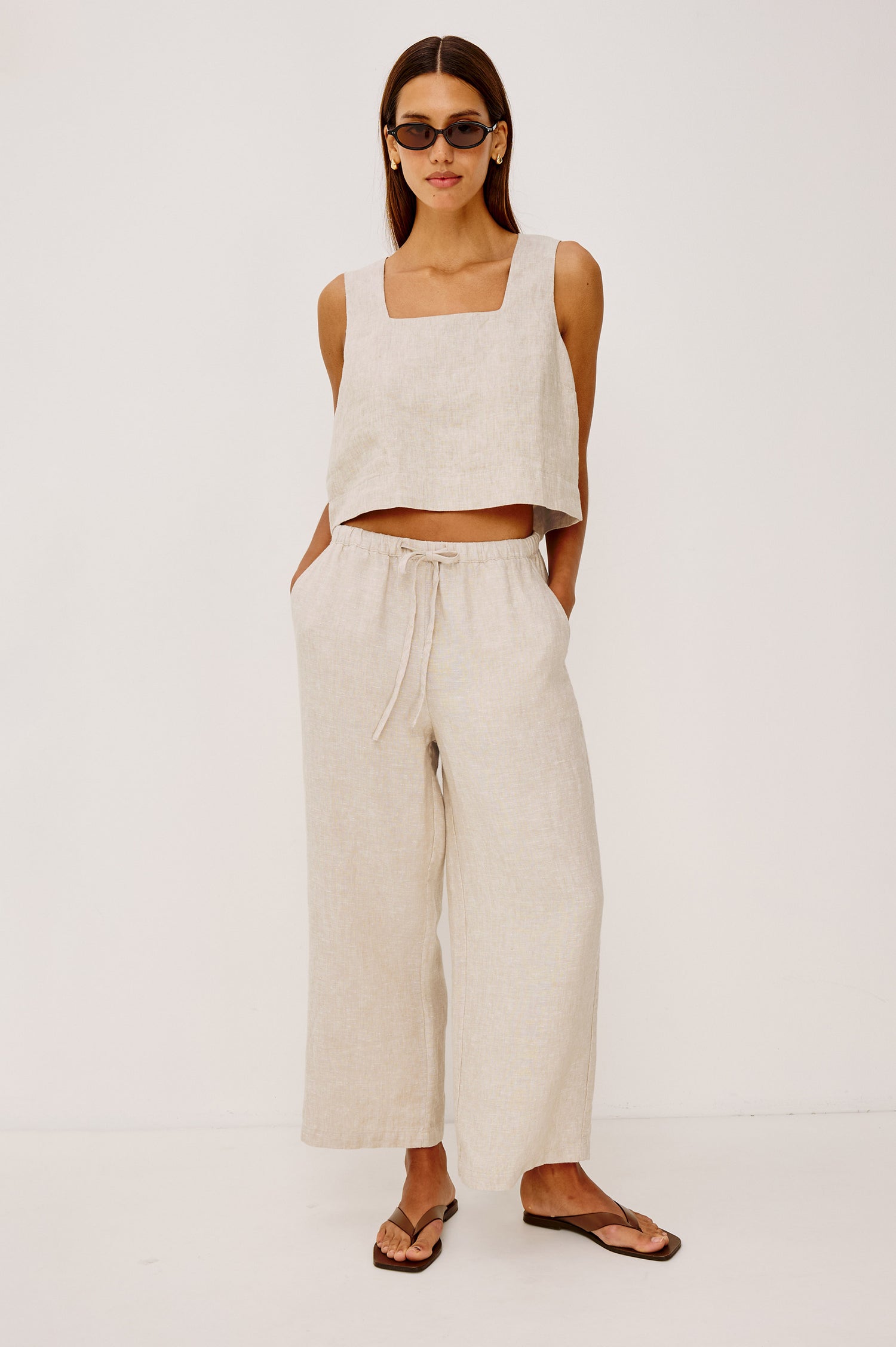 Emmie Crop Pant in Linen With Straight Legs, Adjustable Drawstring Waist Ties, and Side Pockets in Heathered Flax Colorway - Full Body Back View Featured on Model