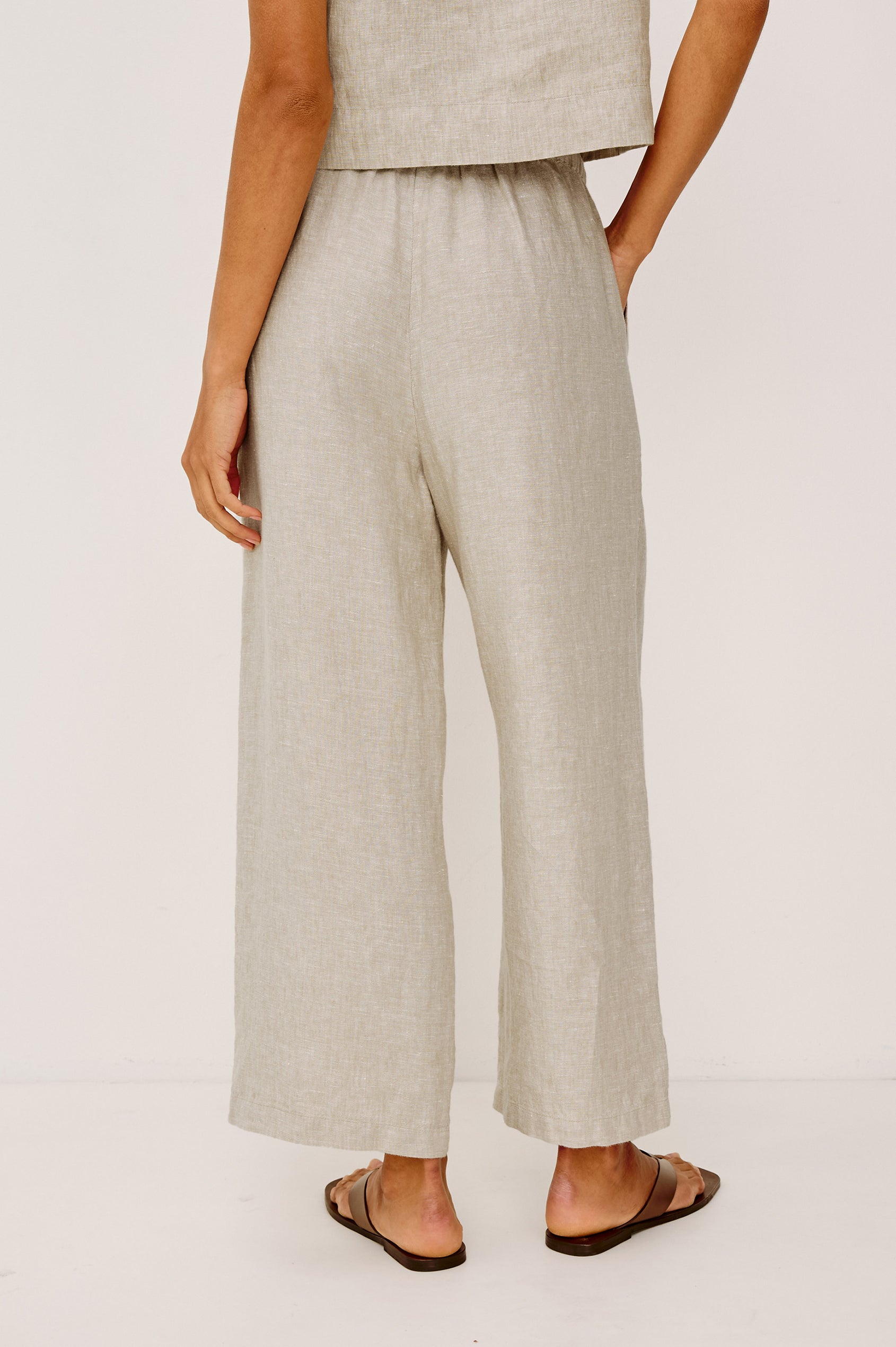 Emmie Crop Pant in Linen With Straight Legs, Adjustable Drawstring Waist Ties, and Side Pockets in Heathered Flax Colorway - Lower Body Back View Featured on Model