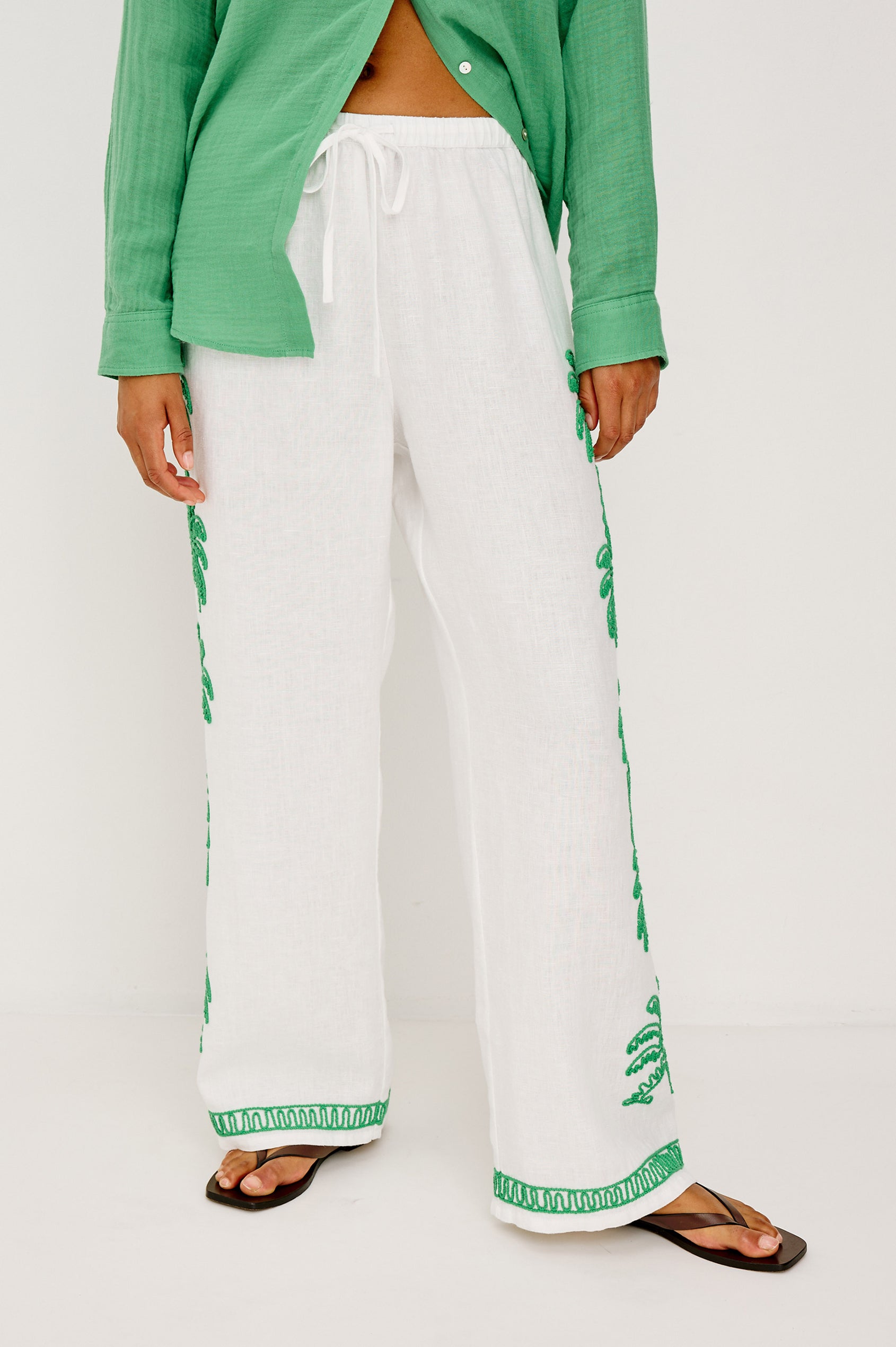 Emmie Straight Leg Pant in Unlined Linen With Adjustable Drawstring Waist Ties and Side Pockets in Emerald Palms Embroidery Colorway — Lower Body Back View Featured on Model