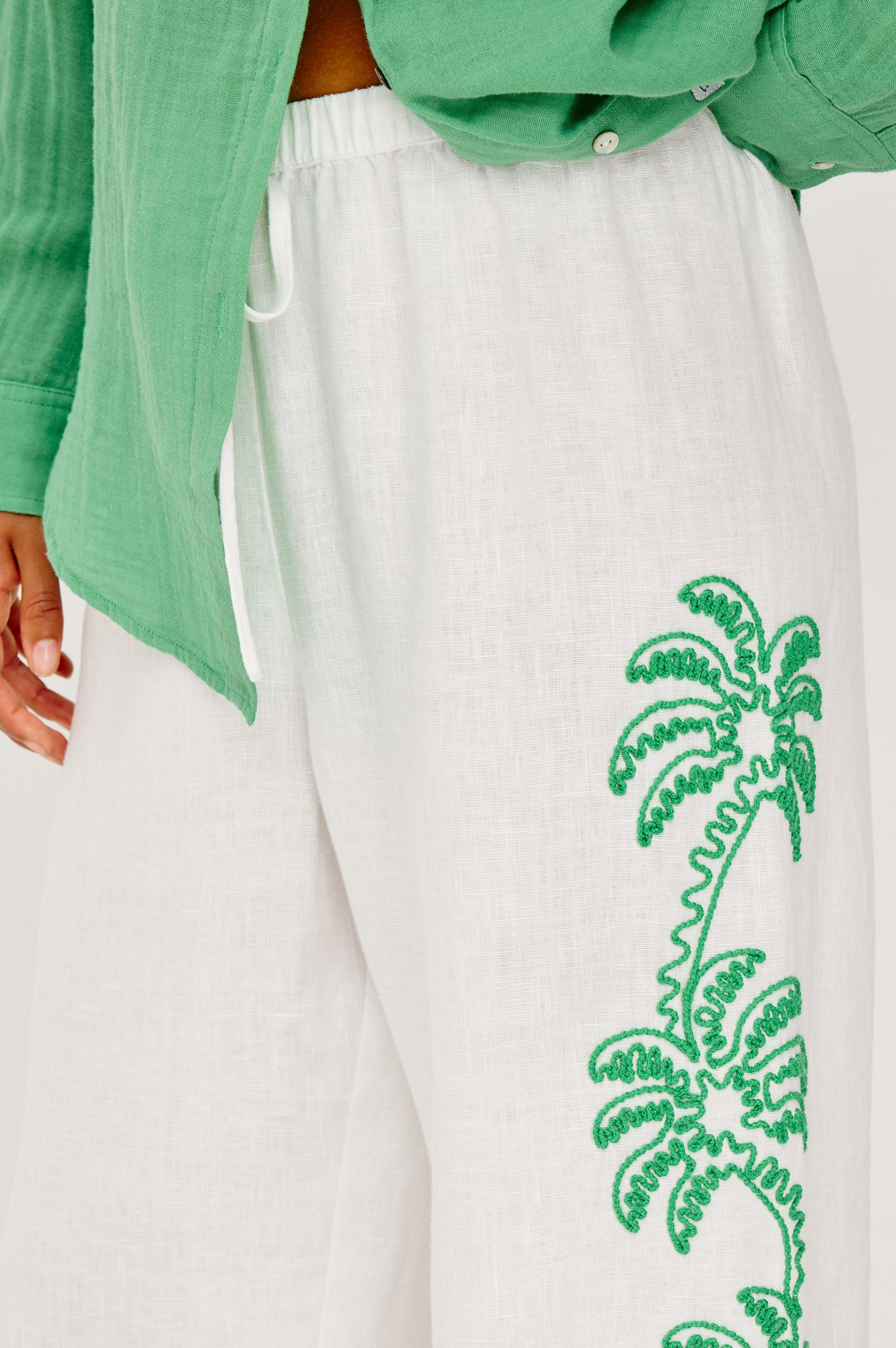 Emmie Straight Leg Pant in Unlined Linen With Adjustable Drawstring Waist Ties and Side Pockets in Emerald Palms Embroidery Colorway — Lower Body Back View Featured on Model