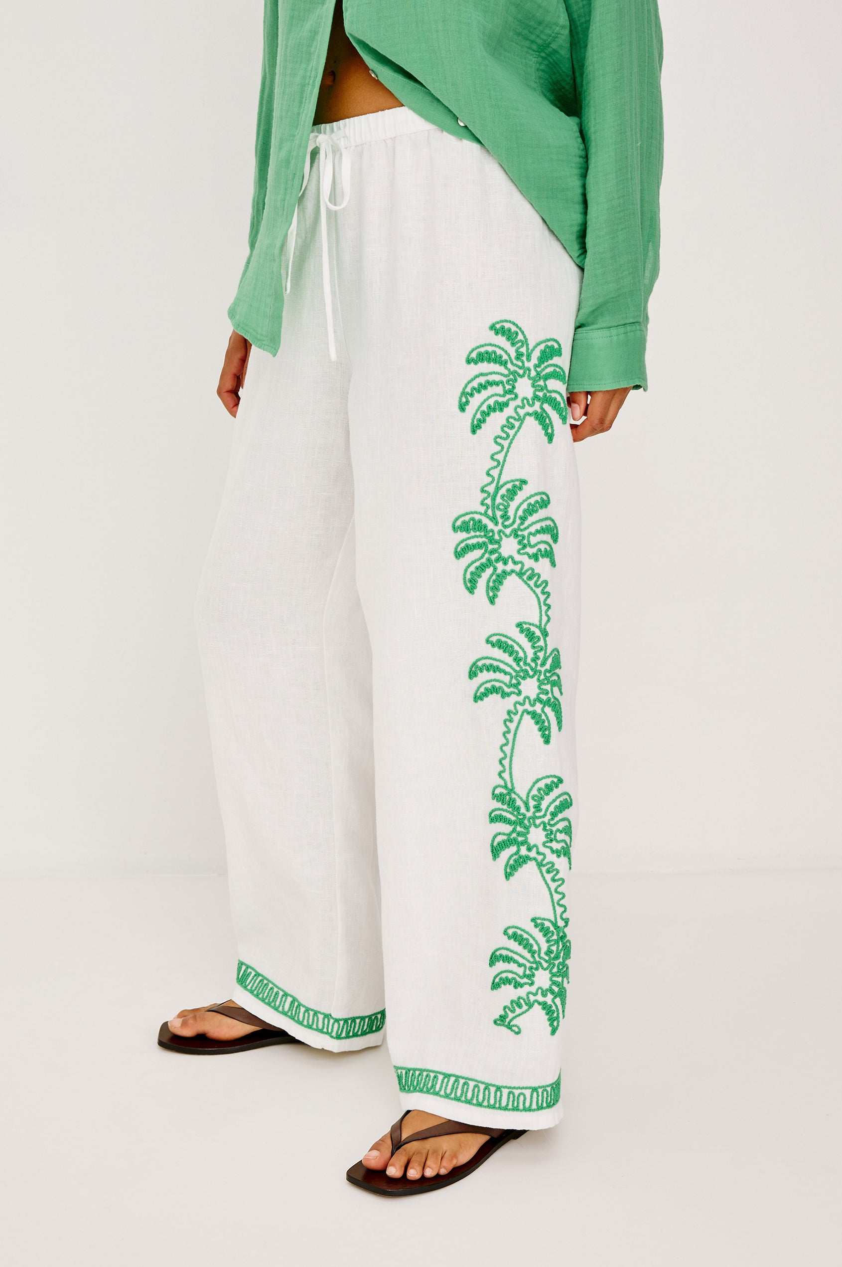 Emmie Straight Leg Pant in Unlined Linen With Adjustable Drawstring Waist Ties and Side Pockets in Emerald Palms Embroidery Colorway — Lower Body Back View Featured on Model