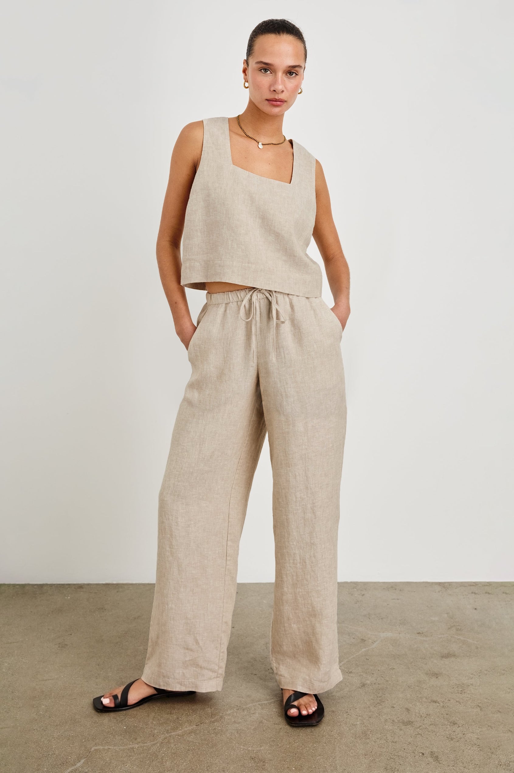 Emmie high rise linen wide leg pant with drawstring and Akira relaxed fit linen crop top with wide straps in Heathered Flax -  full body front view on model