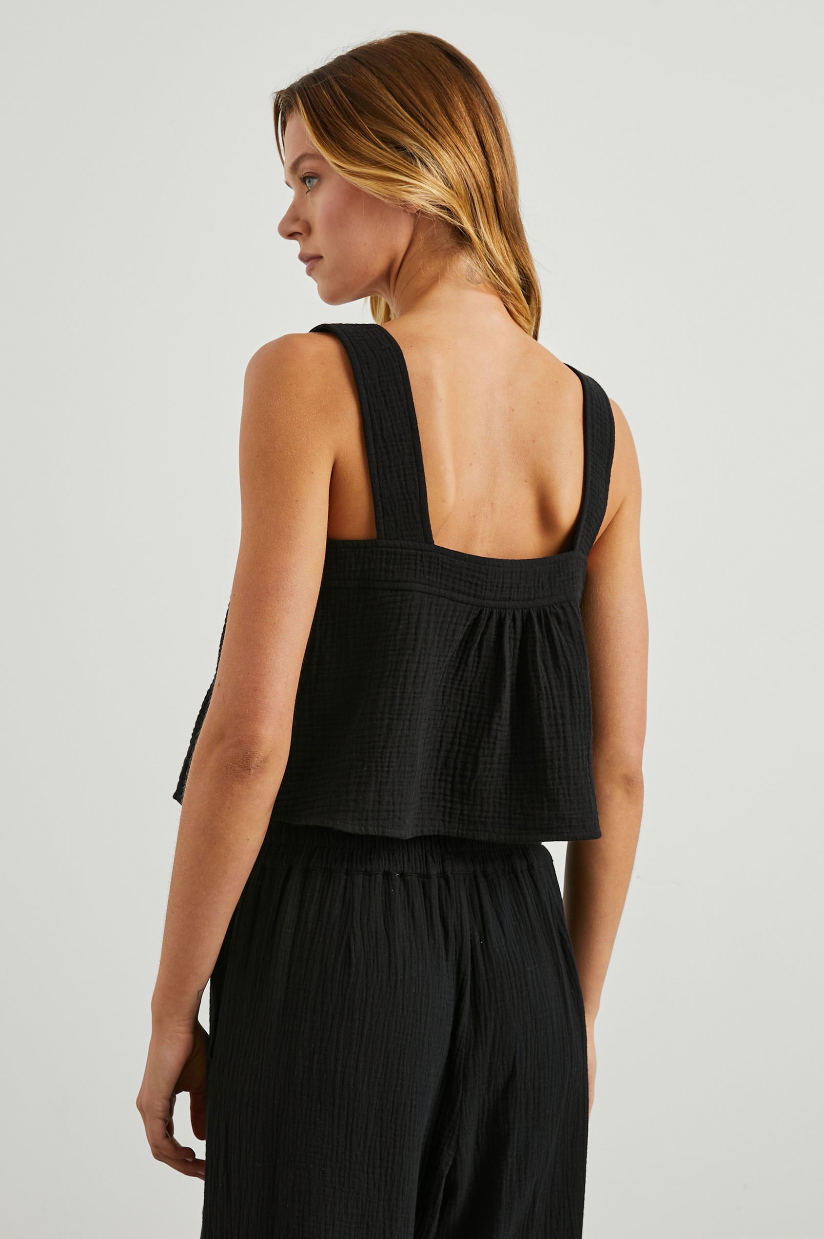 Enya Cropped Tank Top with a Square Neck with a V Cutout with Ties in Black Gauze Colorway - Back View Featured on Model