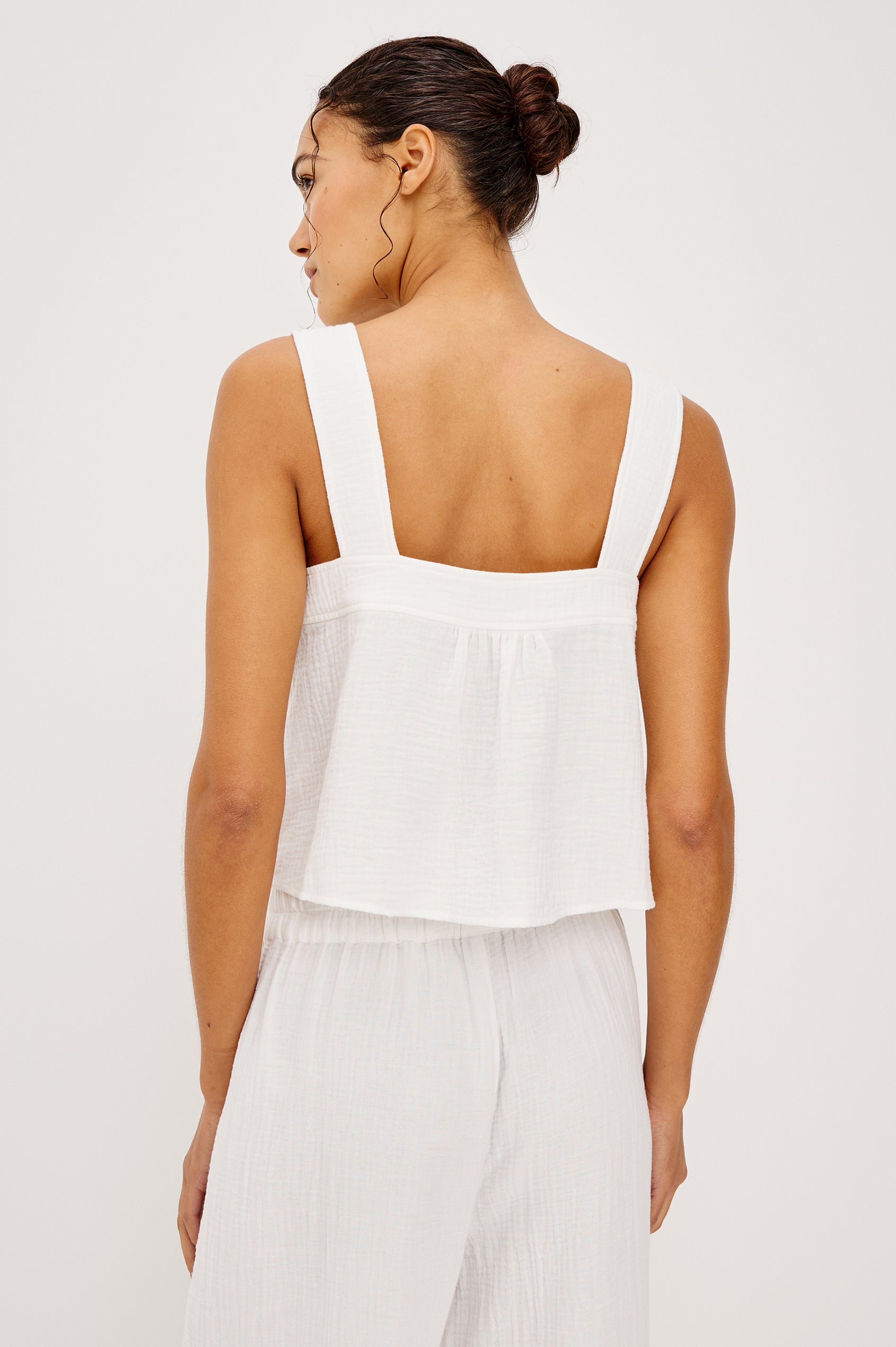 Enya Cropped Tank Top in Cotton Gauze With Square Neckline Wide Shoulder Straps Center Bust Keyhole With Adjustable Ties and Relaxed Fit in White Colorway - Upper Body Front View Featured on Model