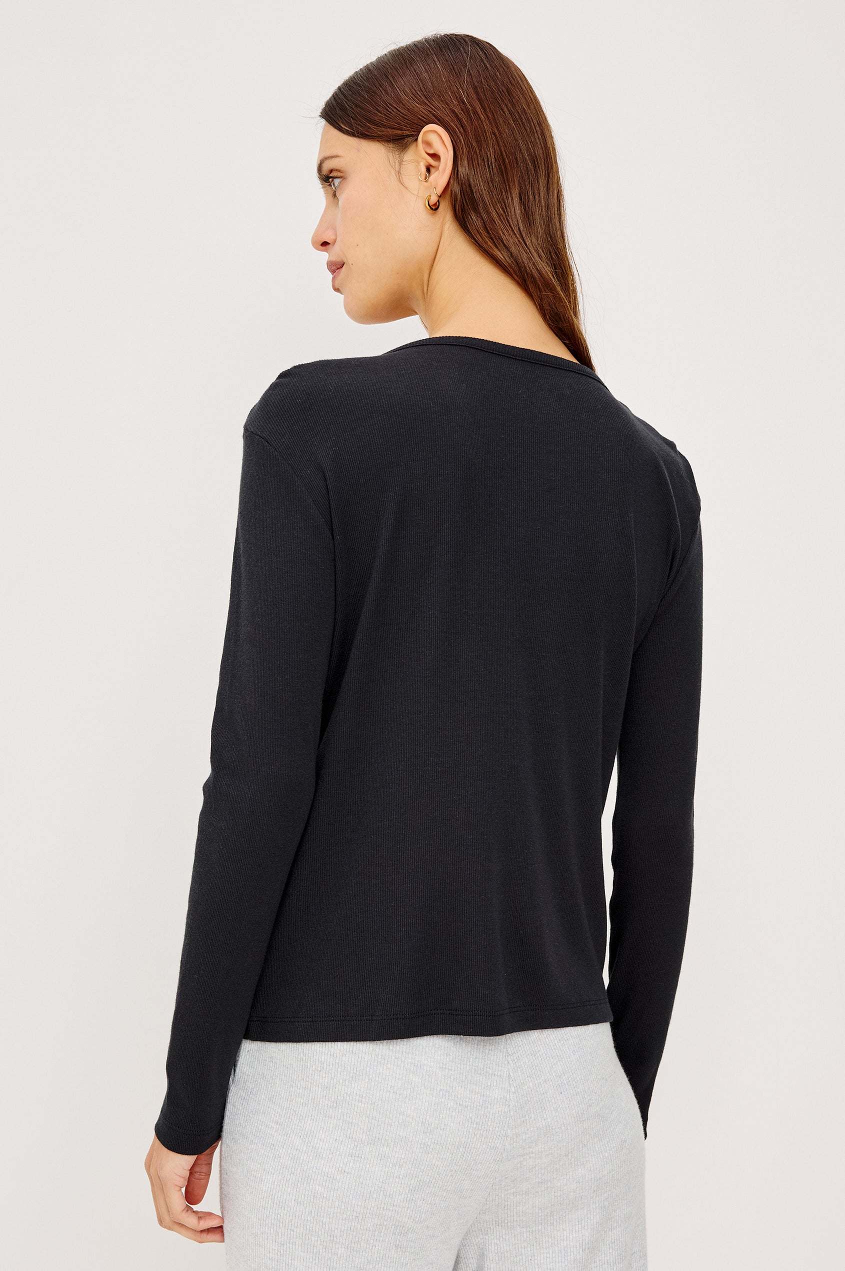 Essential Long-Sleeve Finely Ribbed Henley, with a V Neck and a Placket with Buttons in Black Colorway - Back View Featured on Model 