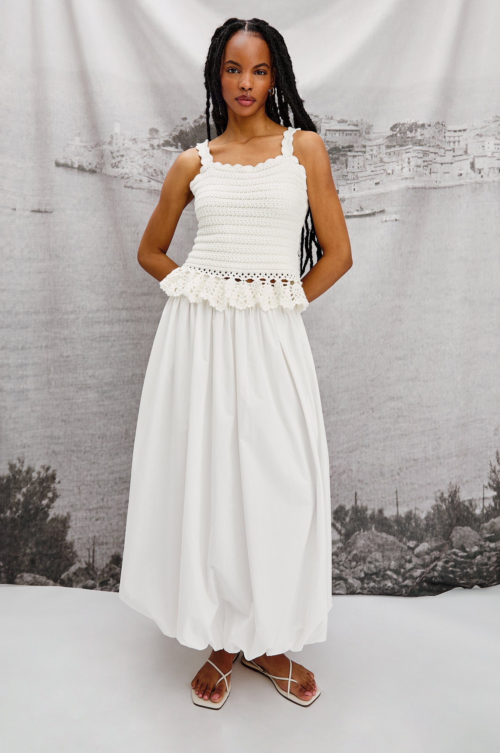 Estefania Tank Top with Scalloped Straps and a Small Peplum Embroidered Ruffle Hem in White Colorway. Stylized Full Body Front View Shown on Model.