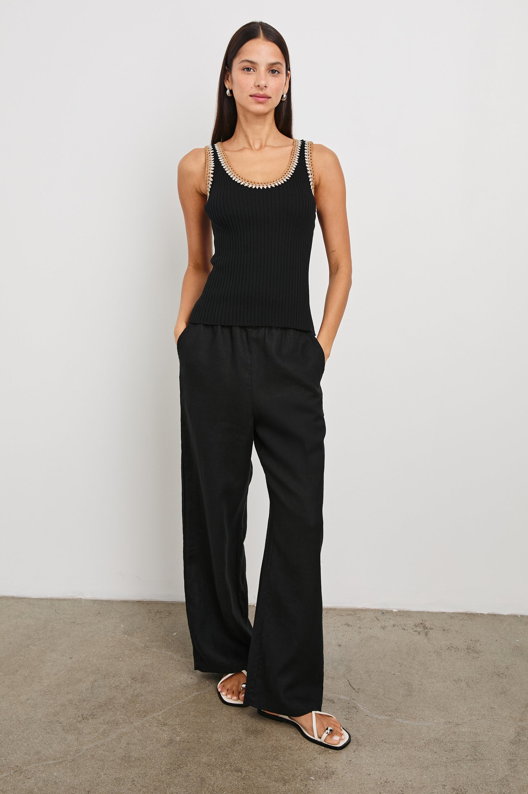 Estrella Ribbed Cami with a Scoop Neck and Crochet Trim Along the Straps and Neckline in Black Colorway with White, Beige, and Tan Trim - Front Full Body View Featured on Model