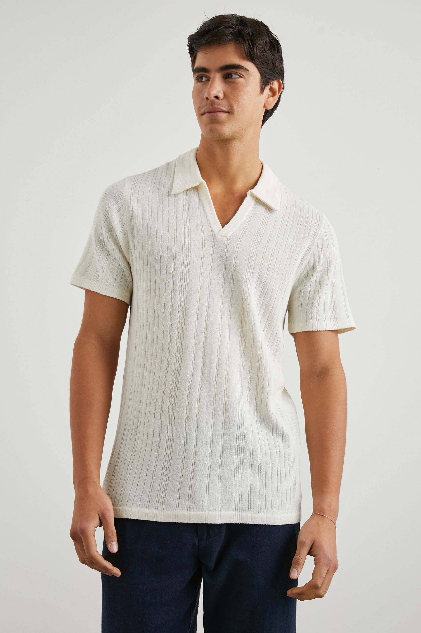Etanne Short Sleeve Polo Shirt with a Buttonless Placket and Textured Vertical Stripes in Ecru Colorway - Front View Featured on Model