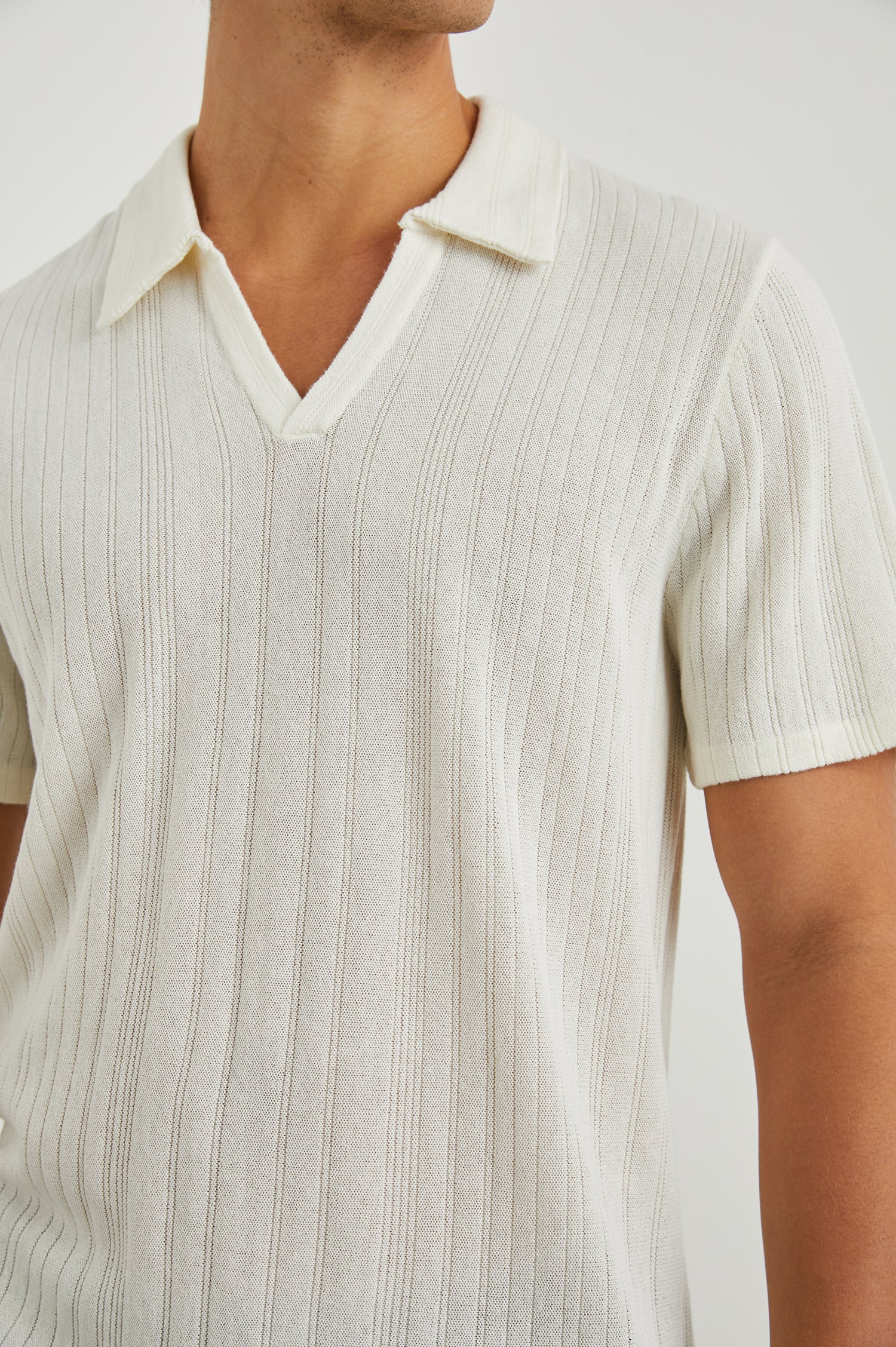Etanne Short Sleeve Polo Shirt with a Buttonless Placket and Textured Vertical Stripes in Ecru Colorway - Front View Featured on Model