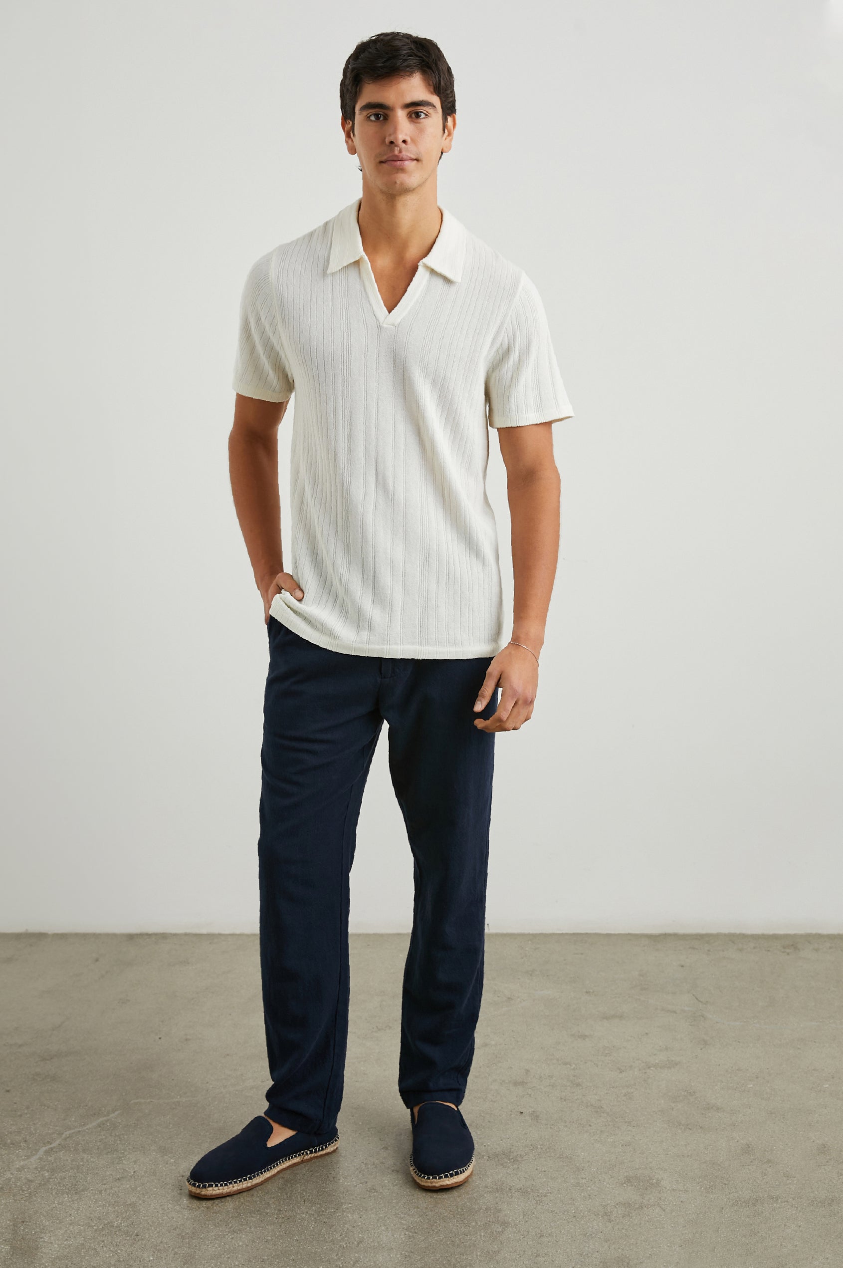 Etanne Short Sleeve Polo Shirt with a Buttonless Placket and Textured Vertical Stripes in Ecru Colorway - Front Full Body View Featured on Model