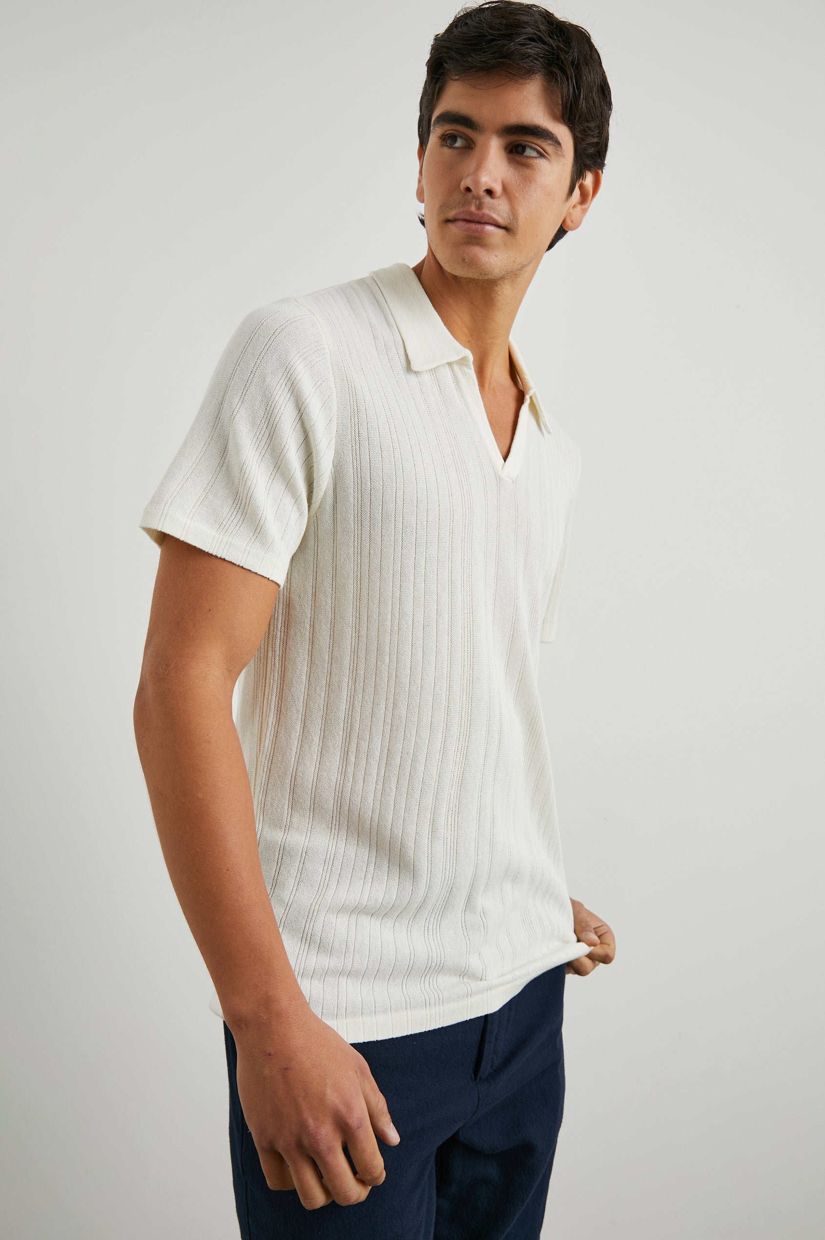 Etanne Short Sleeve Polo Shirt with a Buttonless Placket and Textured Vertical Stripes in Ecru Colorway - Side View Featured on Model