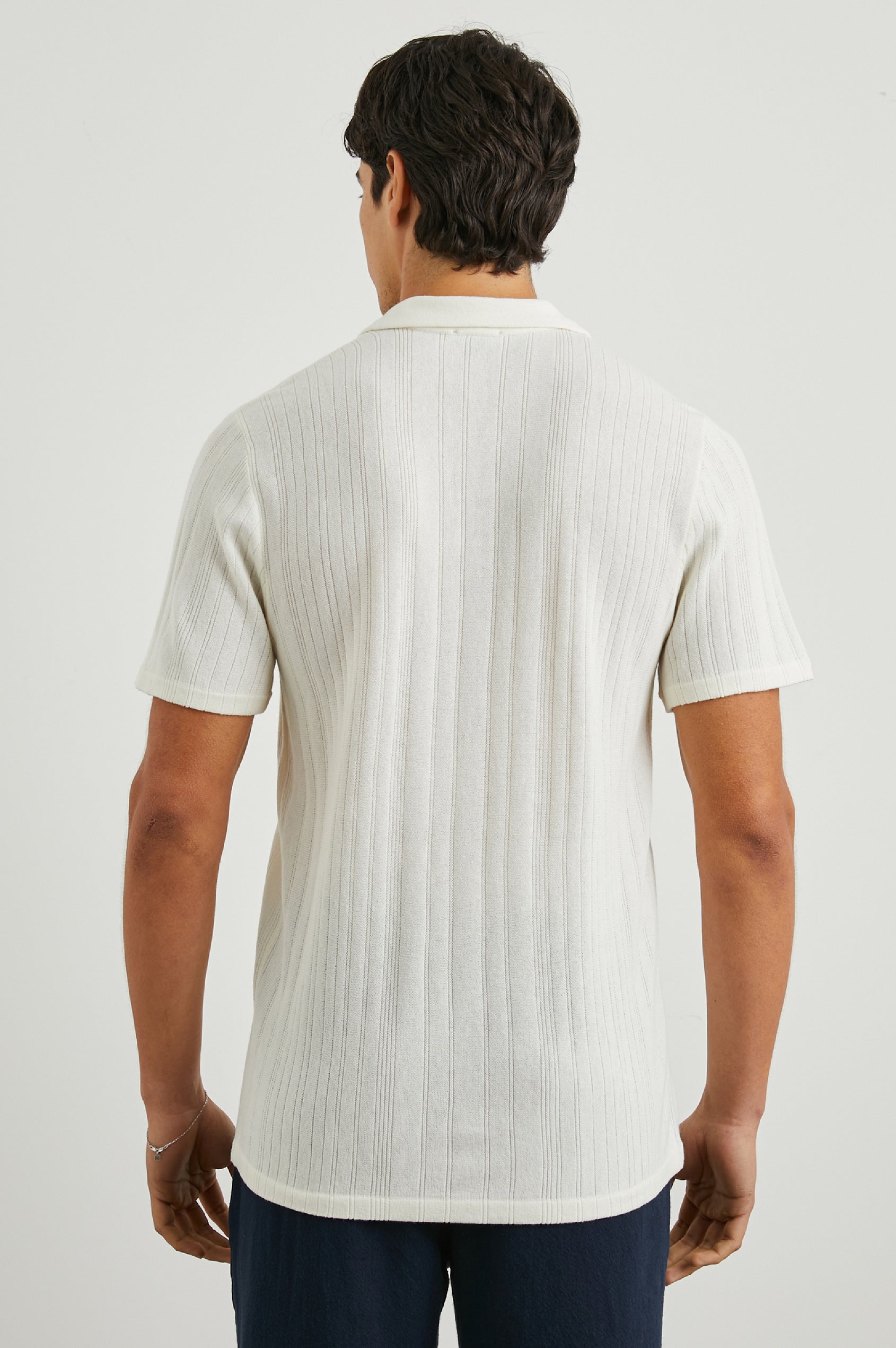 Etanne Short Sleeve Polo Shirt with a Buttonless Placket and Textured Vertical Stripes in Ecru Colorway - Back View Featured on Model