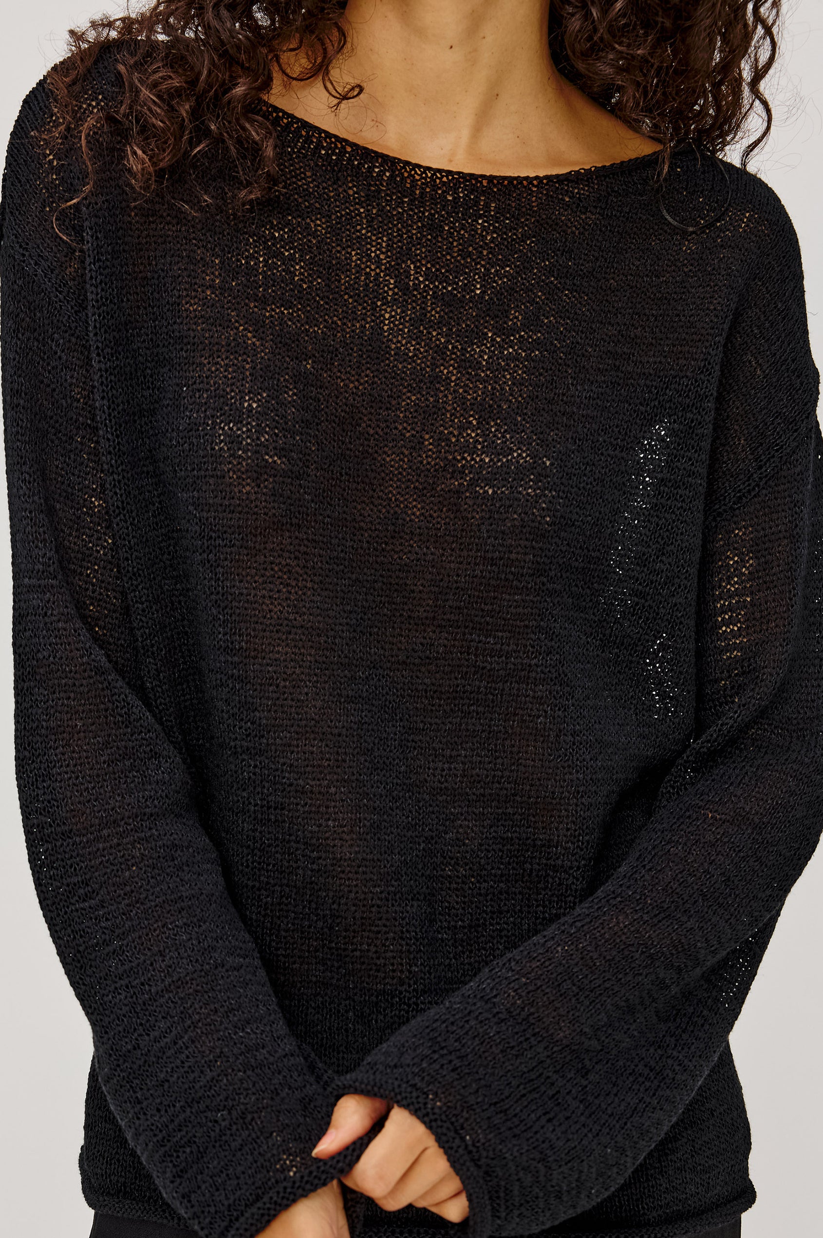 Evangeline Sweater in Luxe Linen Blend With Open Weave, Boat Neck, Relaxed Dropped Shoulders, and Long Sleeves in Black Colorway - Upper Body Front View Featured on Model