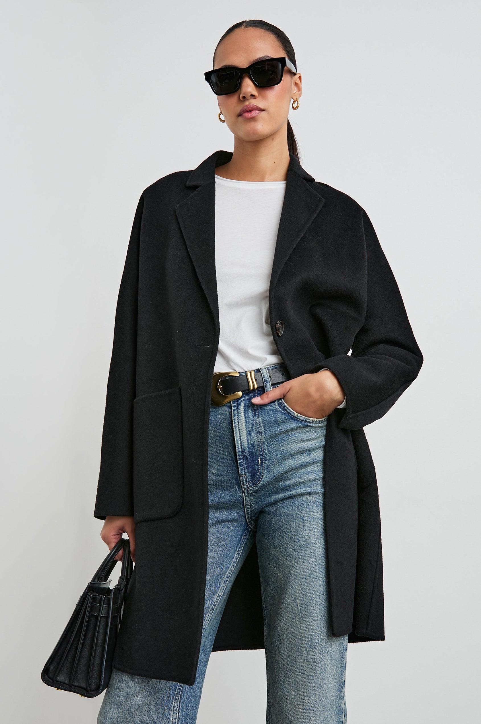 Everest Mid-Thigh Length Coat with Single Button Closure, Notched Lapels and Front Patch Pockets in Black Colorway - Front Full Body View Featured on Model