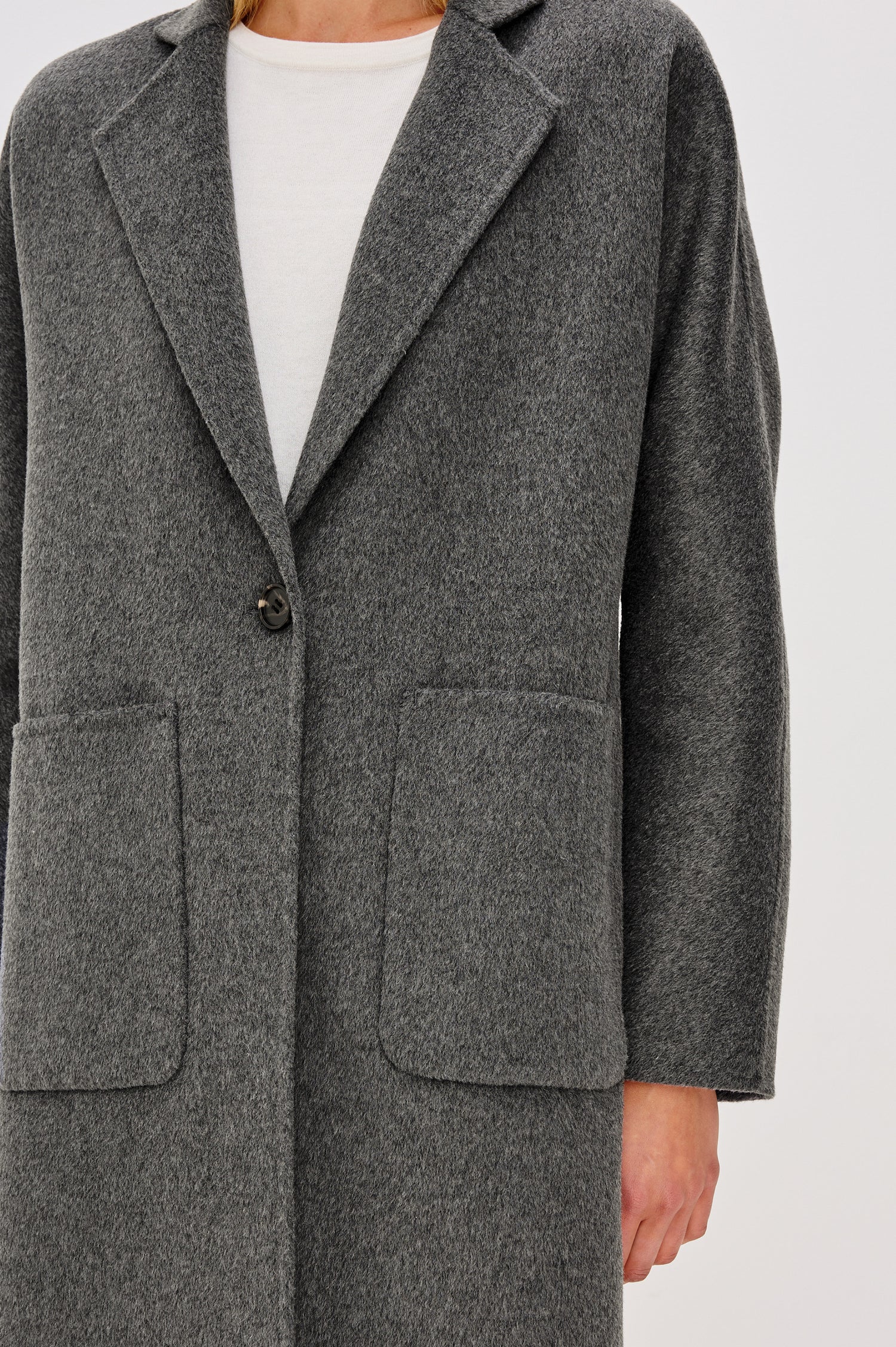 Everest Mid-Thigh Length Coat with Single Button Closure, Notched Lapels and Front Patch Pockets in Charcoal Colorway - Close Up View Featured on Model