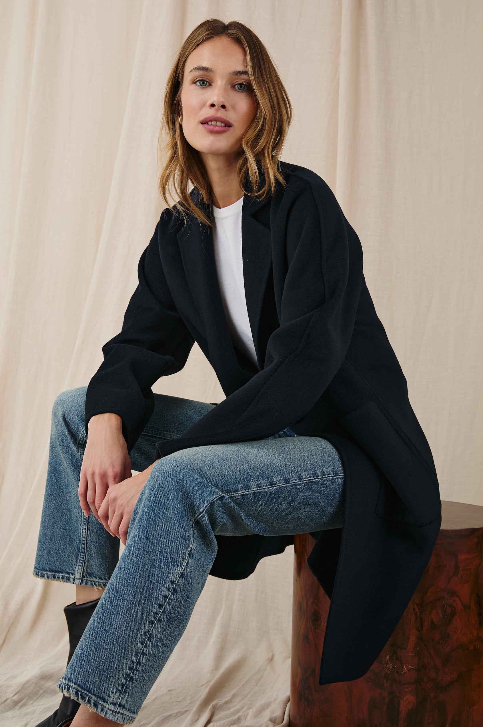 Everest Mid-Thigh Length Coat with Single Button Closure, Notched Lapels and Front Patch Pockets in Navy Colorway - Front Full Body View Featured on Seated Model