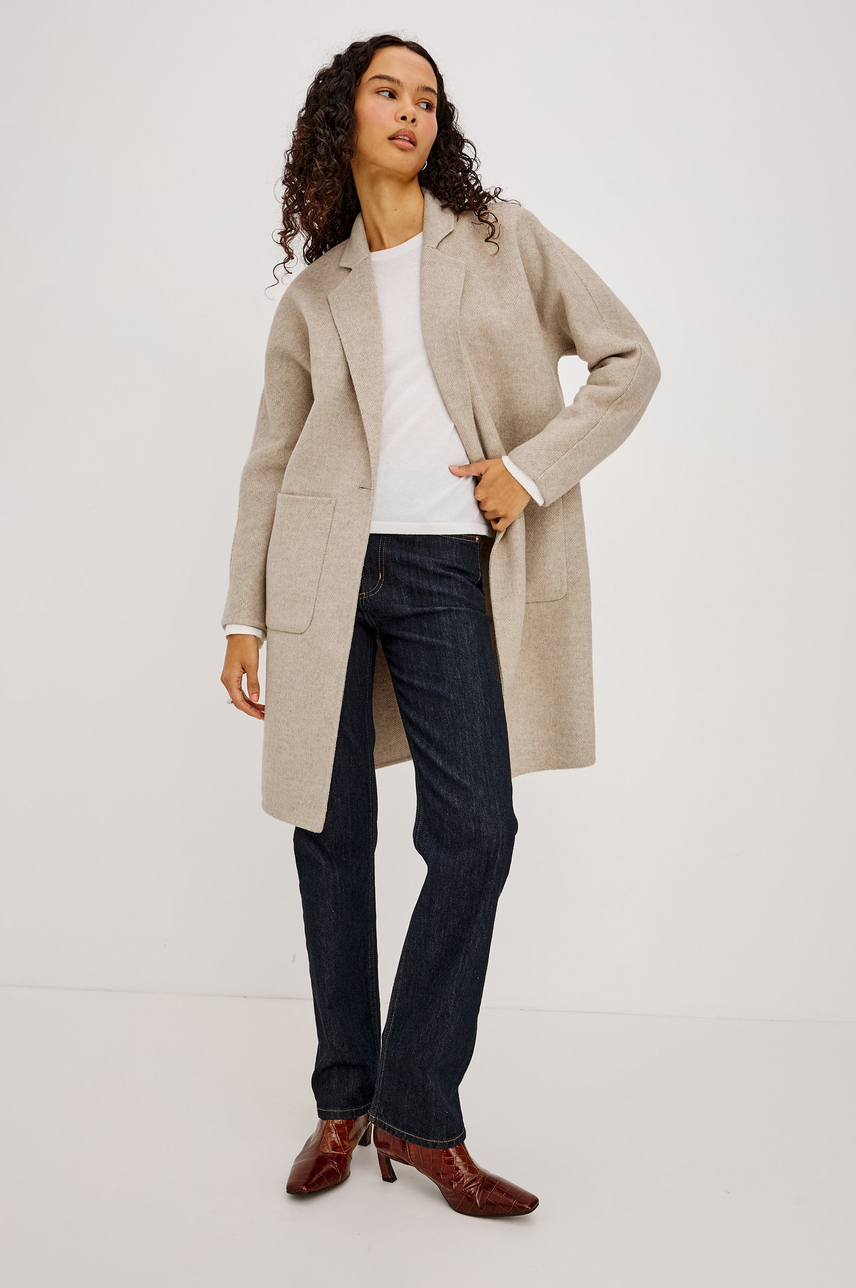 Everest Coat in Heavy Wool Blend With Longline Cut, Slightly Oversized Relaxed Fit, Lapel Collar, Single-Button Front, and Front Patch Pockets in Oat Herringbone Colorway - Full Body Front View Featured on Model