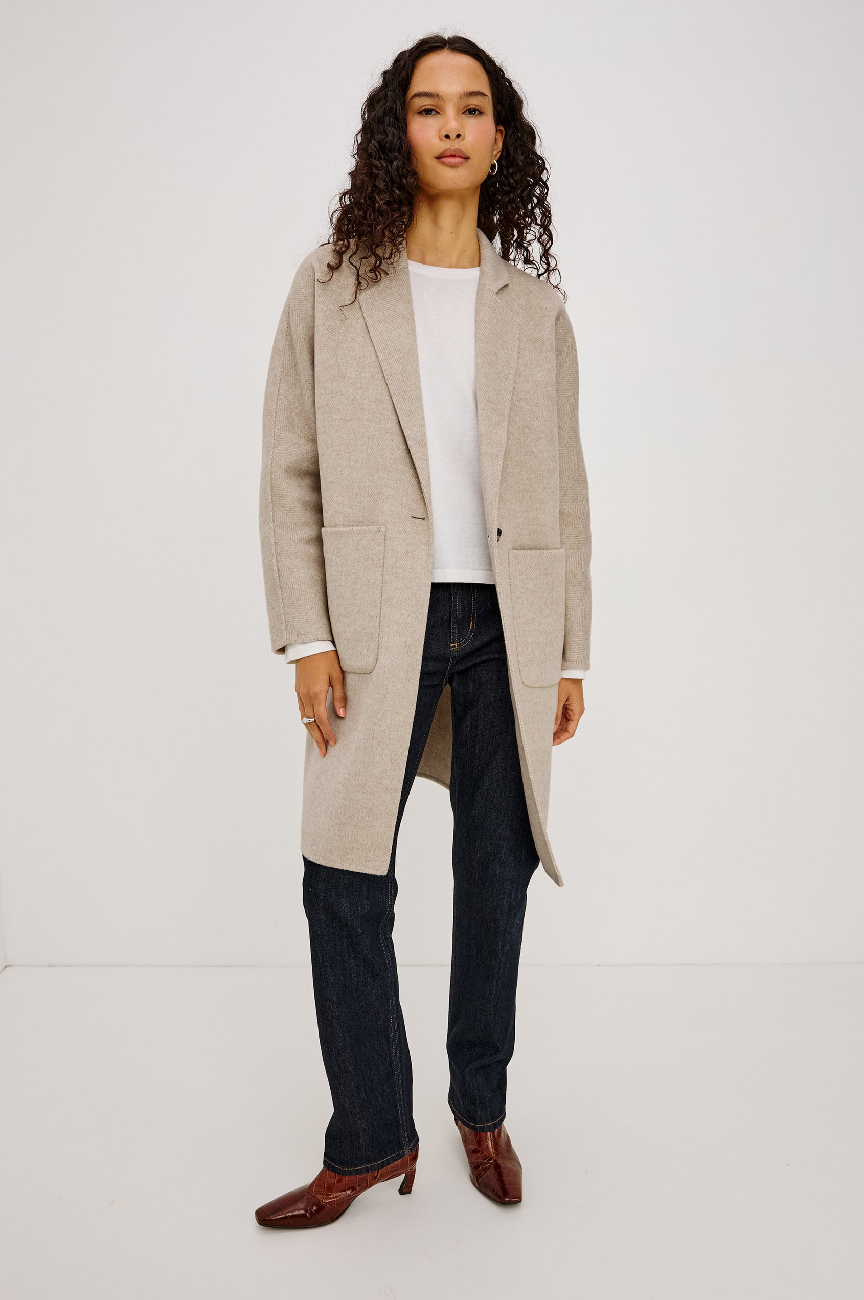 Everest Coat in Heavy Wool Blend With Longline Cut, Slightly Oversized Relaxed Fit, Lapel Collar, Single-Button Front, and Front Patch Pockets in Oat Herringbone Colorway - Full Body Front View Featured on Model