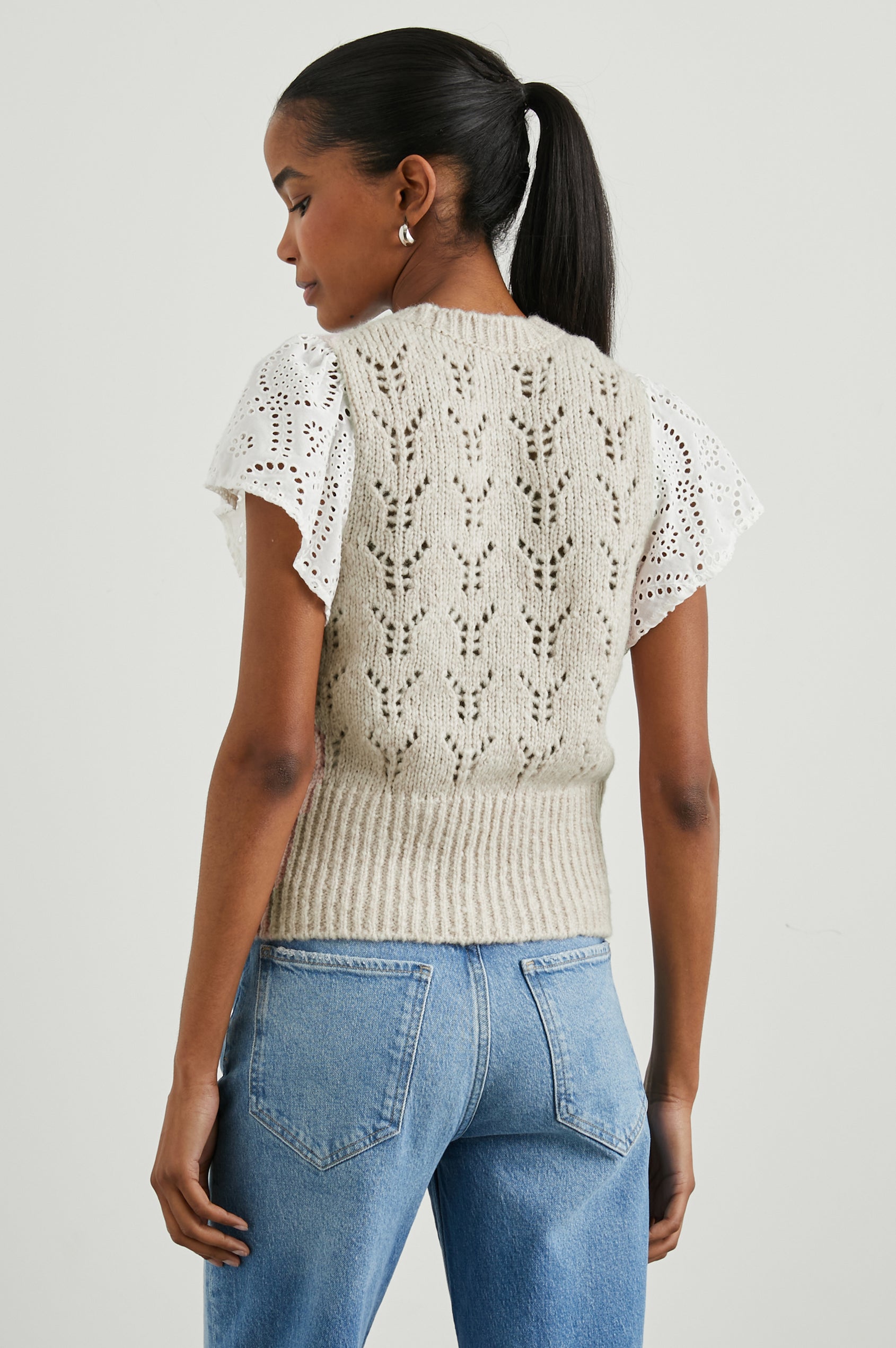 Everly Top with a Knit Bodice with Ribbed Trim and a Crew Neck and White Cotton Short Sleeves with Eyelets In Oat Colorway - Back View Featured on Model