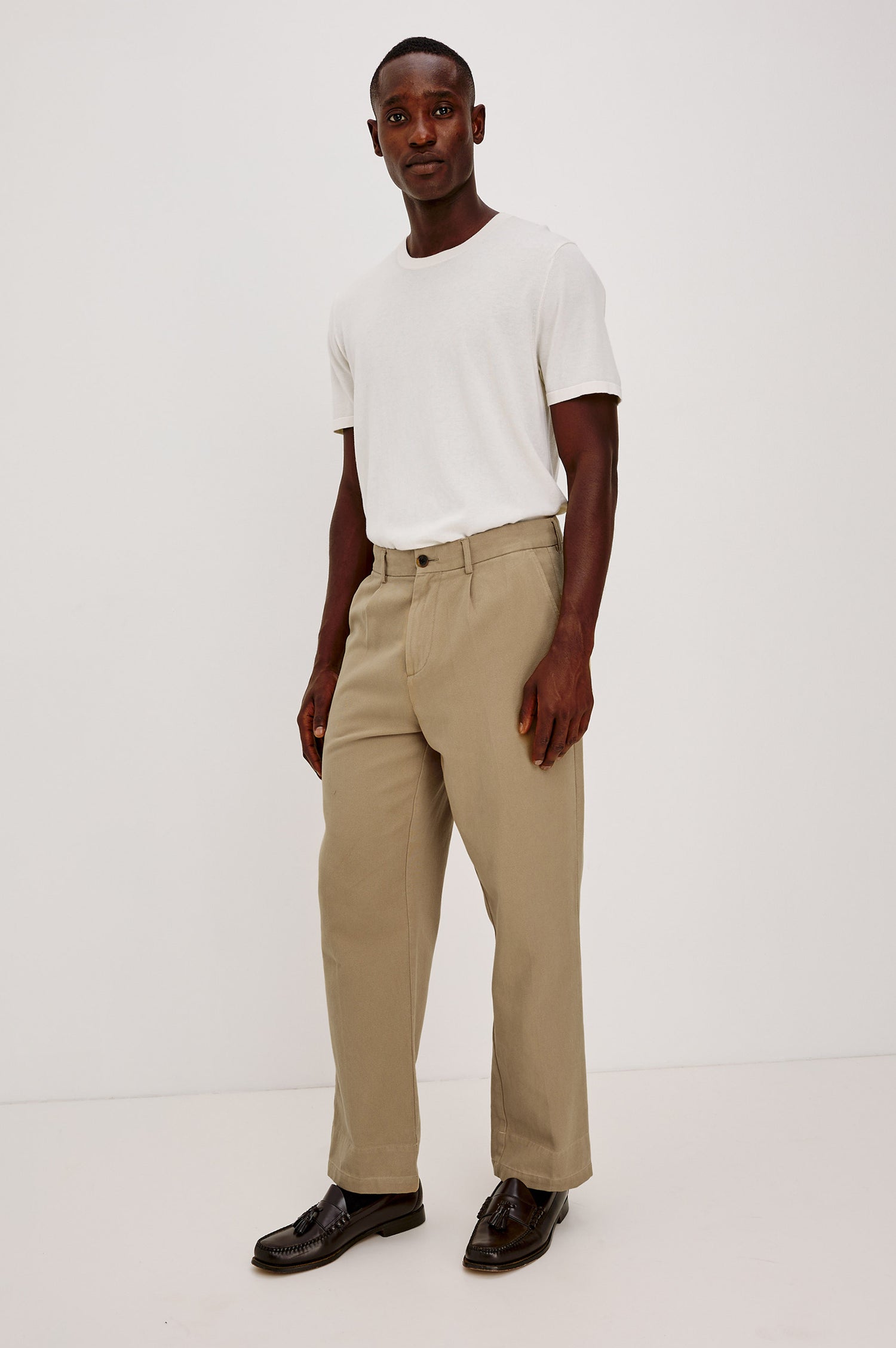 Ezra Pant in Brushed Cotton Twill With Relaxed Fit, Single Front Pleats, Ankle-Length Hem, Zip Fly, Side Pockets, and Back Double-Welt Pockets in British Khaki Colorway - Full Body Front View Featured on Model
