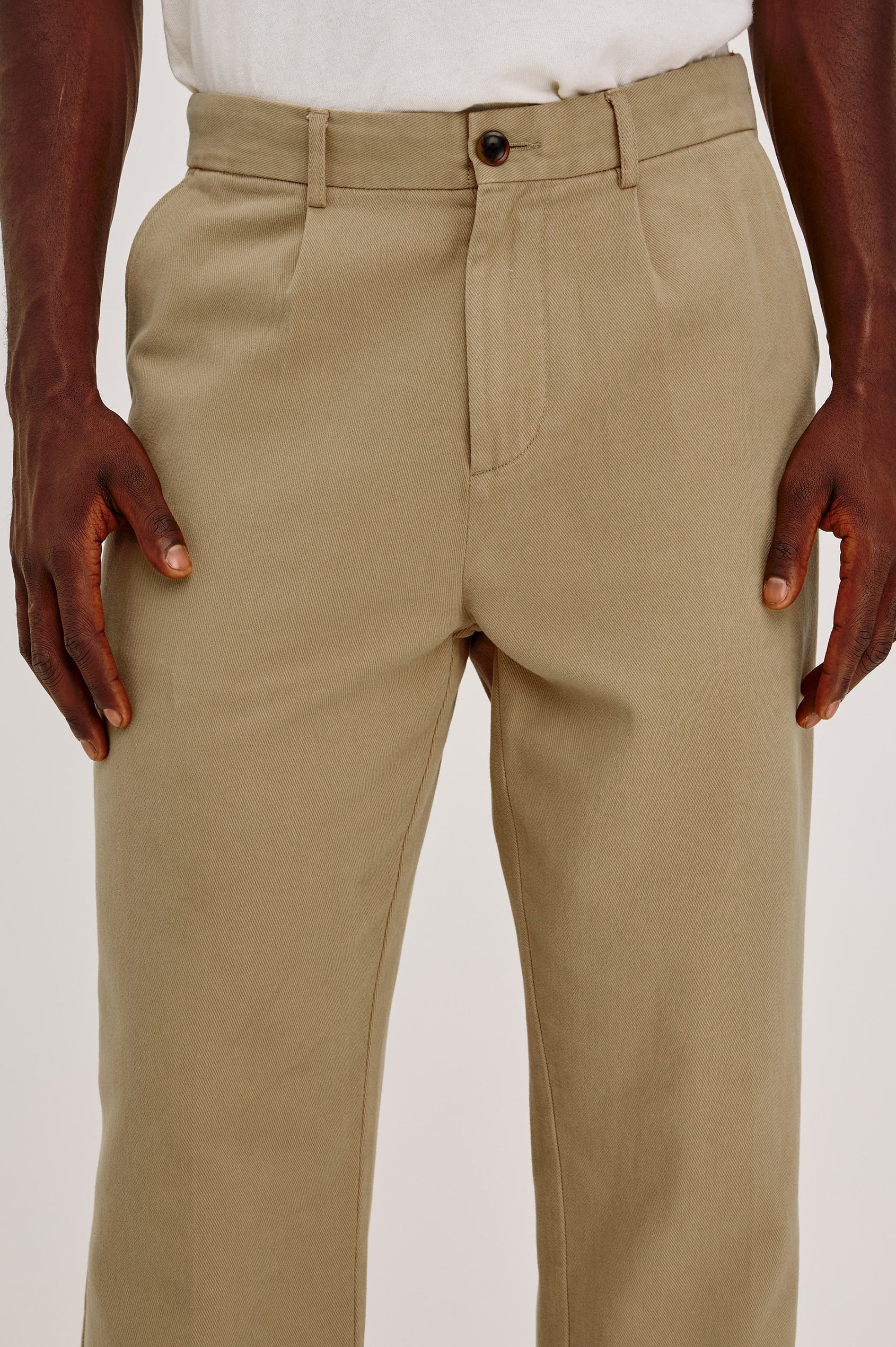 Ezra Pant in Brushed Cotton Twill With Relaxed Fit, Single Front Pleats, Ankle-Length Hem, Zip Fly, Side Pockets, and Back Double-Welt Pockets in British Khaki Colorway - Lower Body Front View Featured on Model
