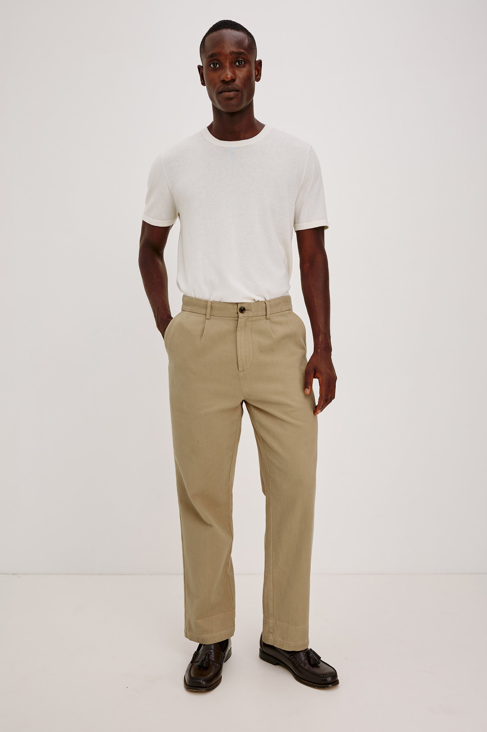 Ezra Pant in Brushed Cotton Twill With Relaxed Fit, Single Front Pleats, Ankle-Length Hem, Zip Fly, Side Pockets, and Back Double-Welt Pockets in British Khaki Colorway - Full Body Front View Featured on Model