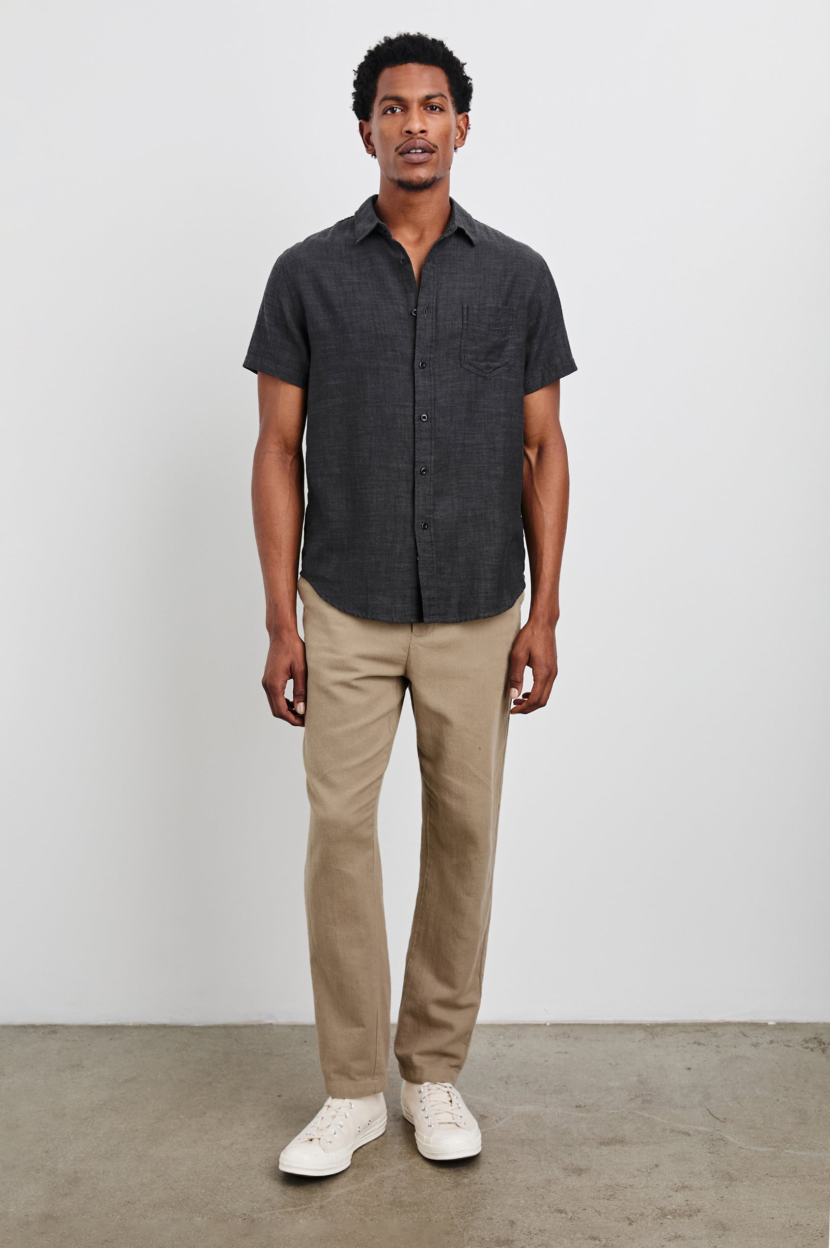 Fairfax Short-Sleeve Button Up with a Chest Patch Pocket in Black Chambray Colorway - Front Full Body View Featured on Model