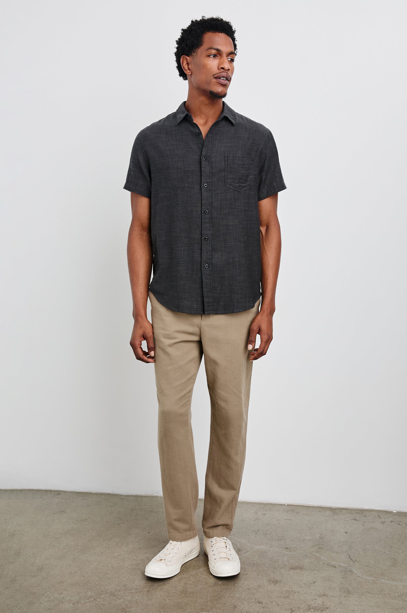 Fairfax Short-Sleeve Button Up with a Chest Patch Pocket in Black Chambray Colorway - Front Full Body View Featured on Model