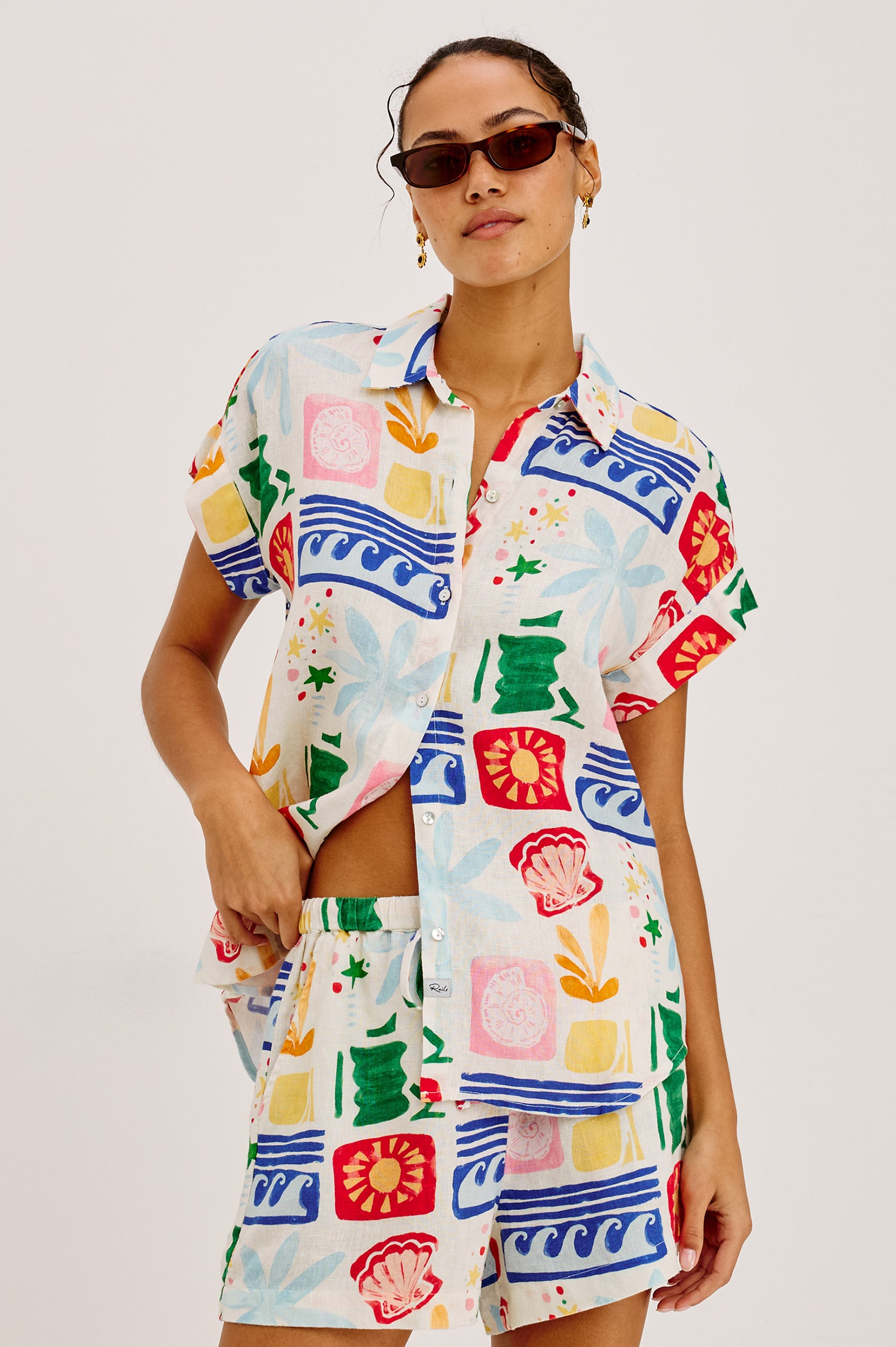 Jenner Short in Linen With High-Rise, Adjustable Drawstring Ties, Relaxed Fit, and Side Pockets in Bahama Colorway - Upper Body Front View Featured on Model