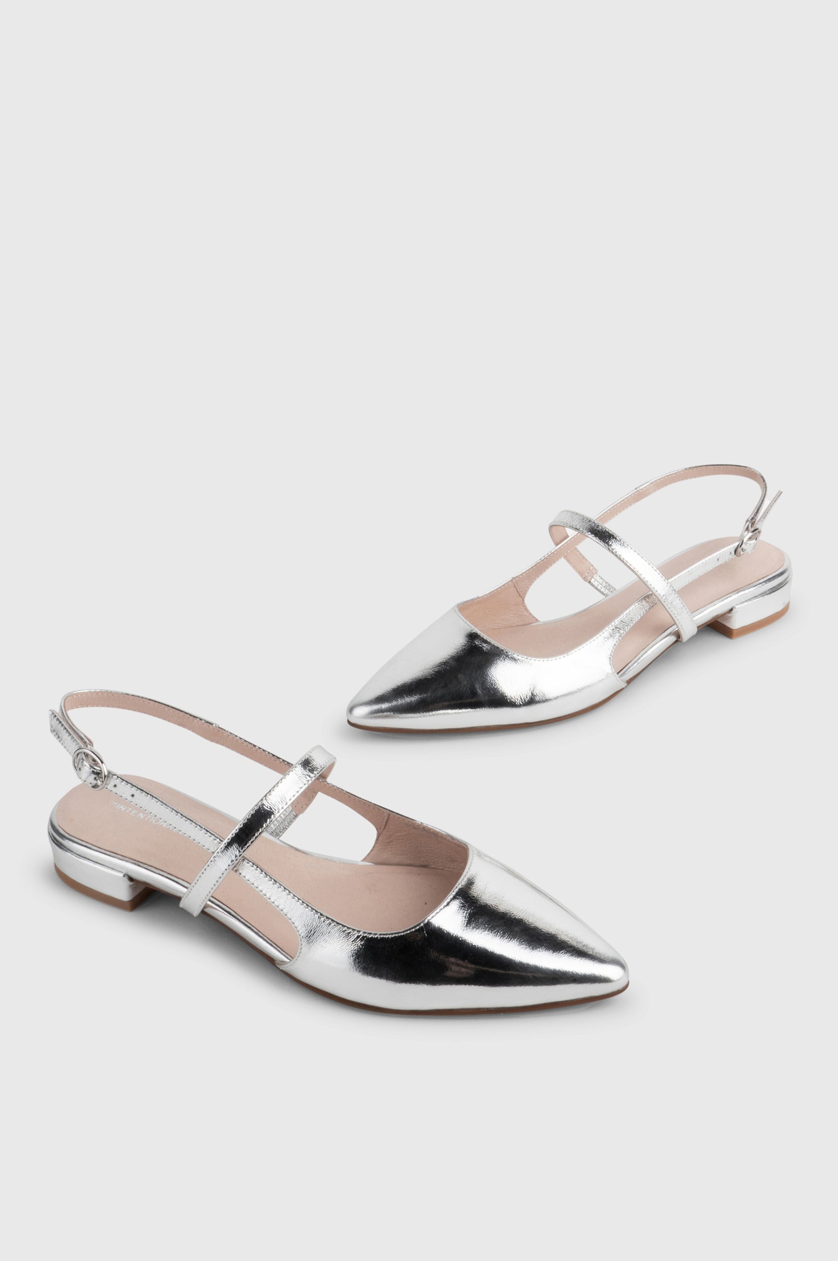 Felix slingback flat with pointed toe and mary jane style strap in metallic Mercury color - cross angle view of shoe pair