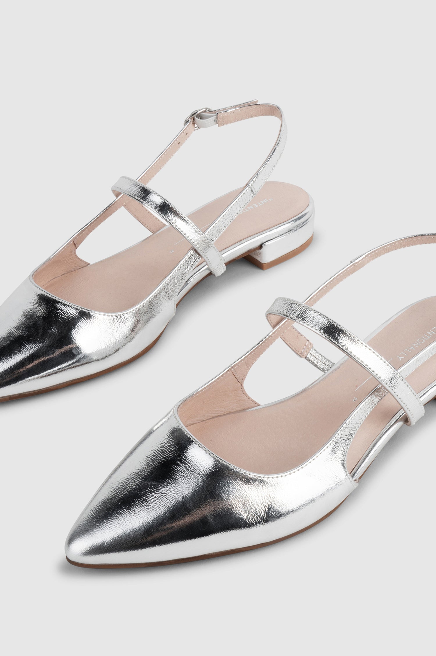 Felix slingback flat with pointed toe and mary jane style strap in metallic Mercury color - close up of toe details