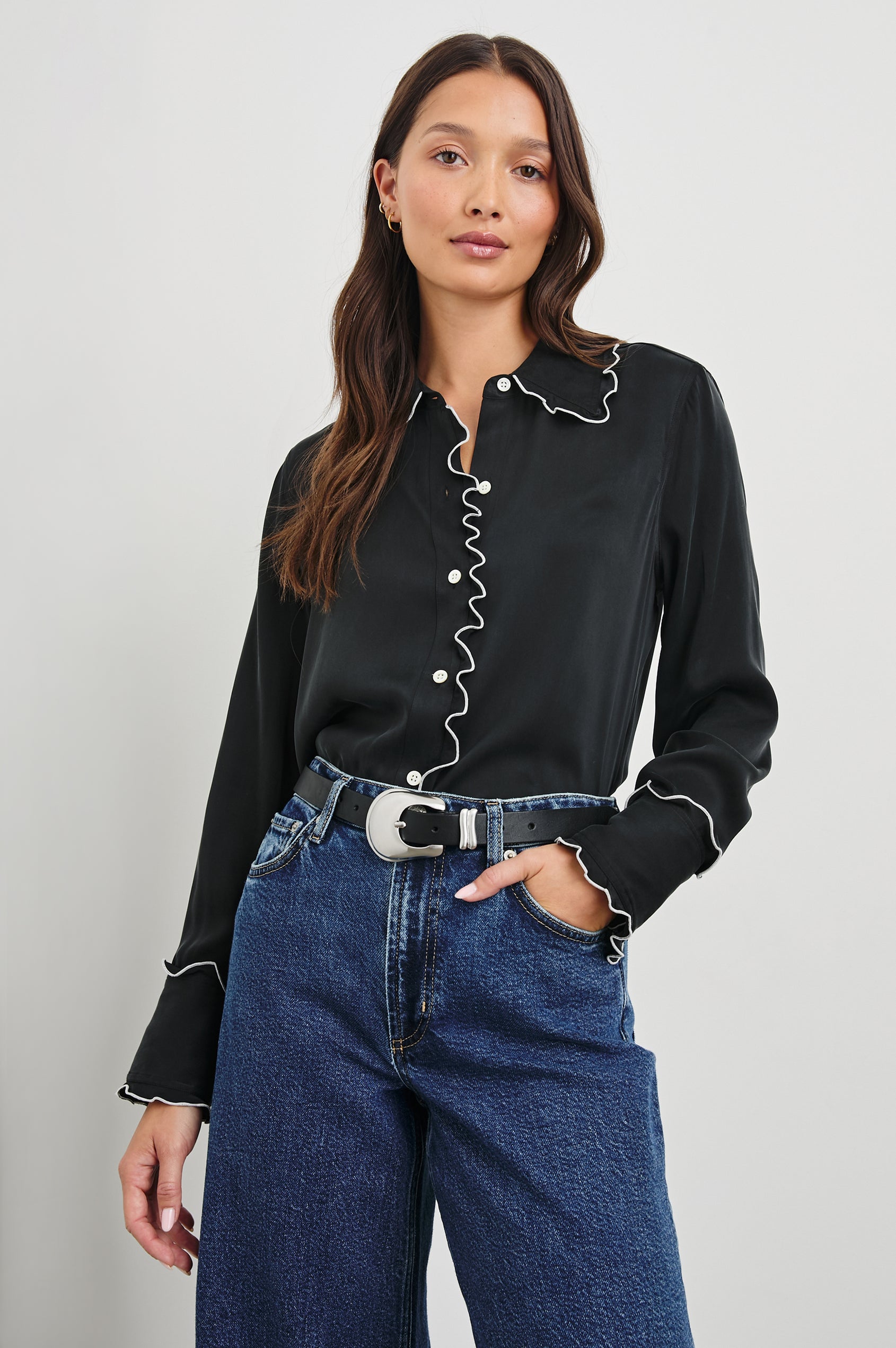 Fia Long-Sleeve Button Up with White Lettuce-Edge Piping on the Collar, Cuffs, and Closure in Black White Piping Colorway - Front Tucked View Featured on Model 