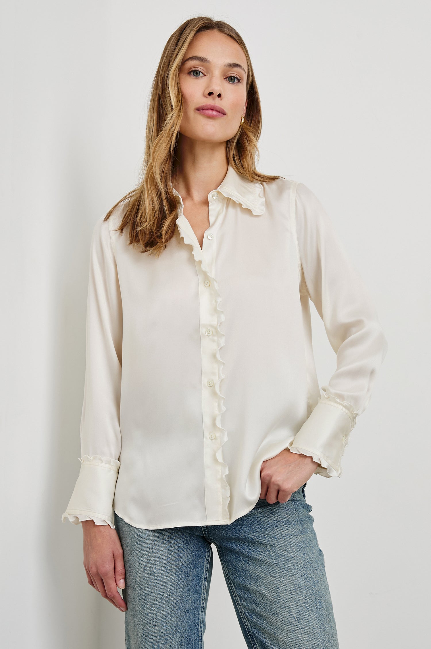 Fia Long-Sleeve Button Up with Lettuce Edges on the Collar, Cuffs, and Closure in Ivory Colorway - Front View Featured on Model 