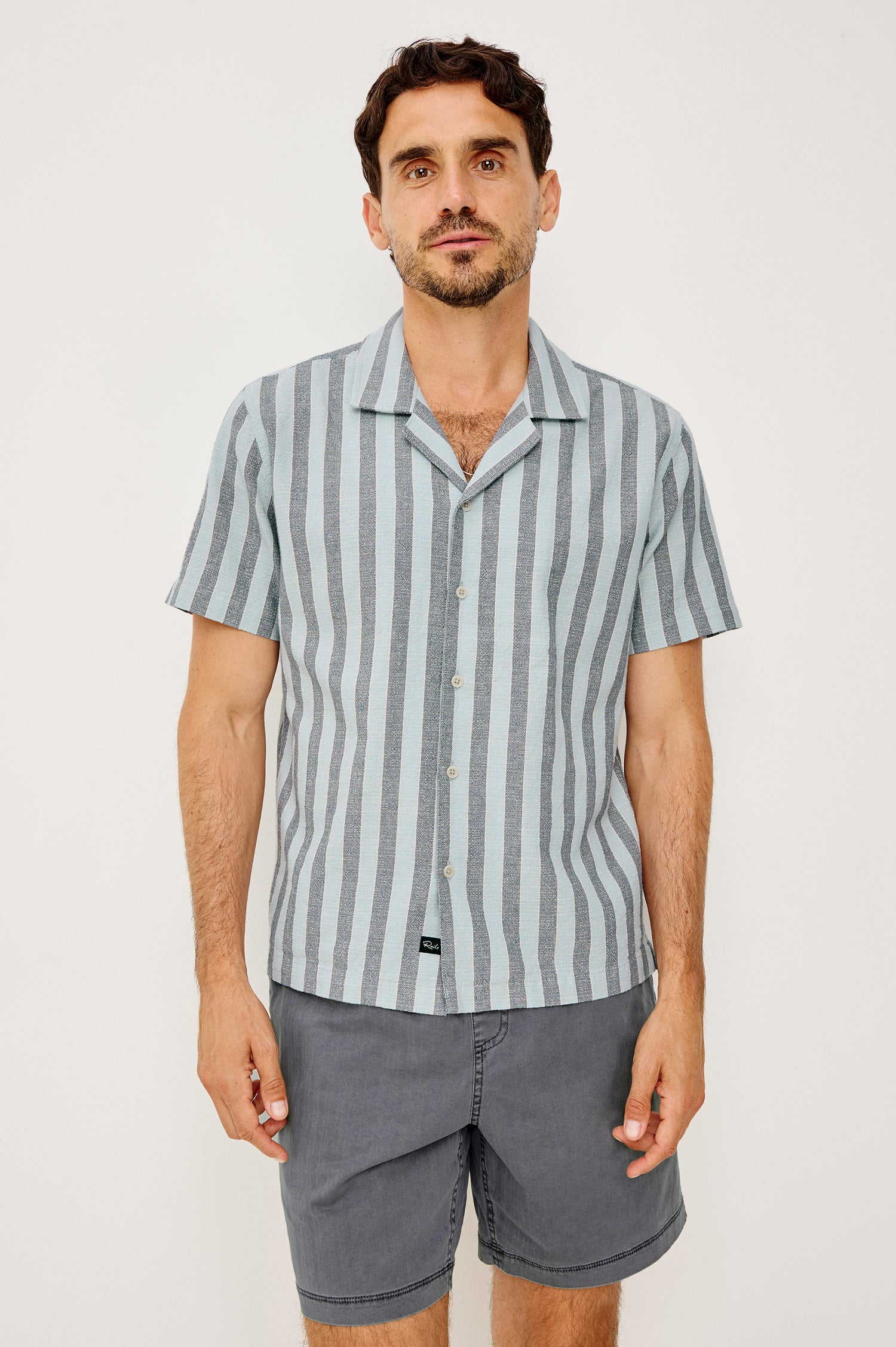 Fielder Camp Shirt With Front Buttons, Short Sleeves, and Relaxed, Boxy Fit in Blue Jay Stripe Colorway - Upper Body Front View Featured on Model
